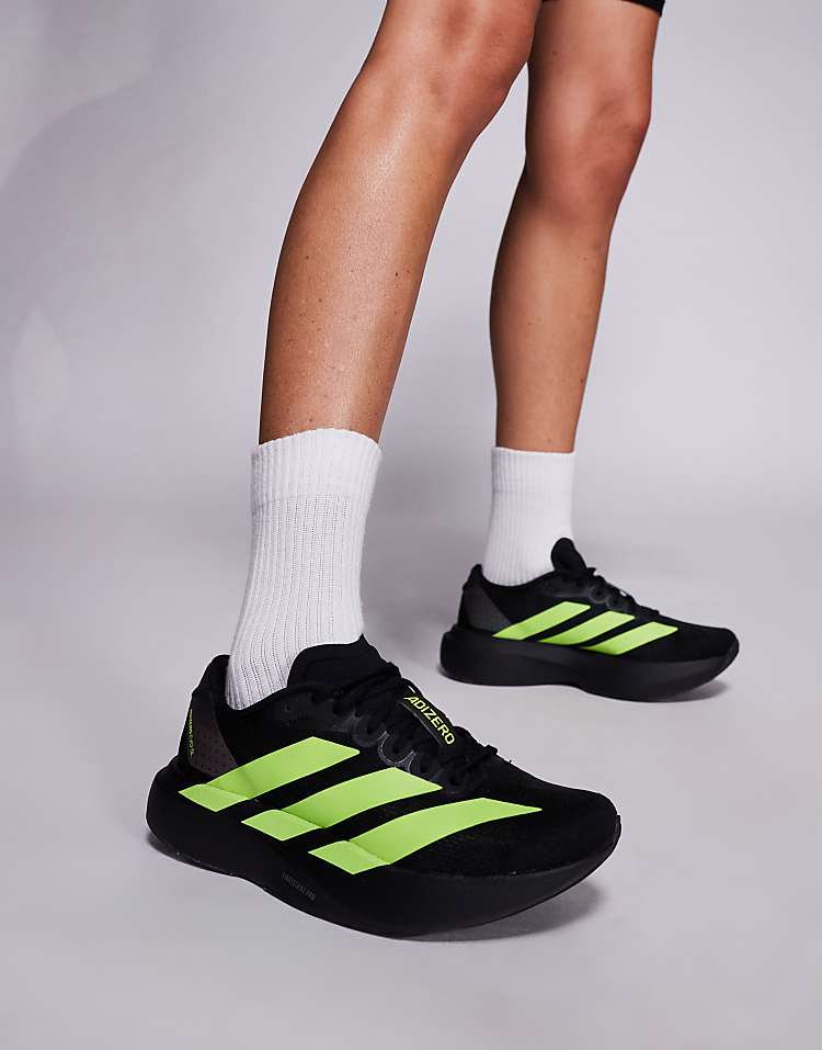 Men wearing black and neon green adidas Adizero Evo SL sneakers with white crew socks