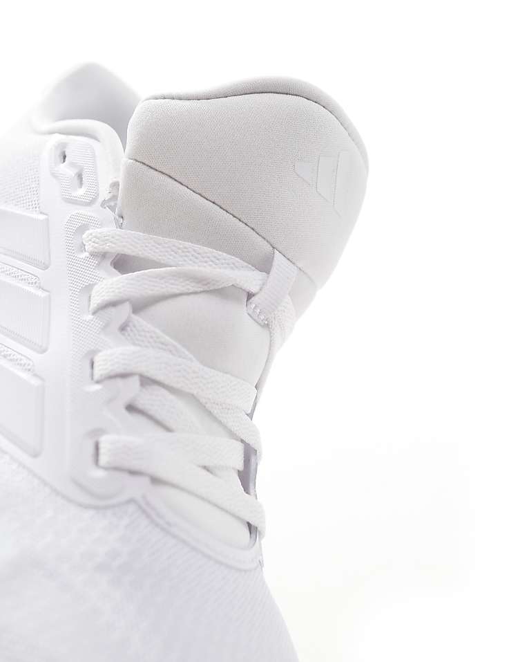 Close-up of white adidas RunFalcon running shoes showing detailed laces and tongue design