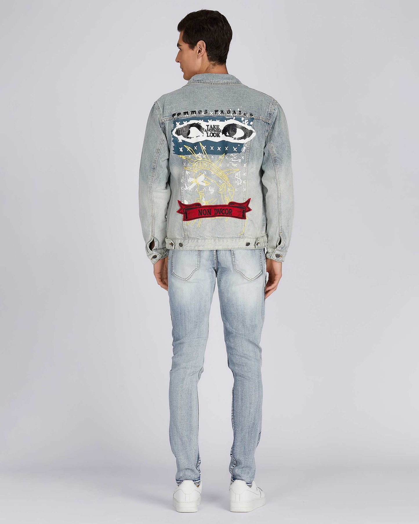 Art painted denim jacket by Logeqi featuring unique graphics on the back and a modern fit.