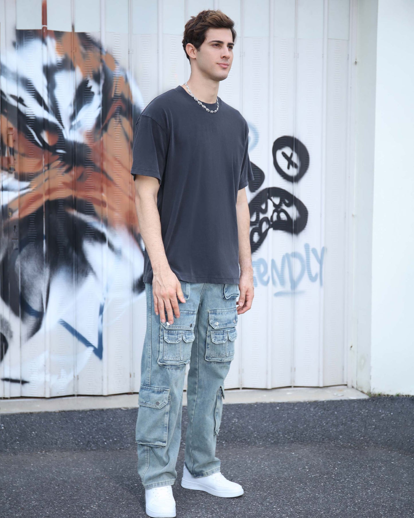 Logeqi black crew neck t-shirt on model, paired with cargo jeans for a casual style.