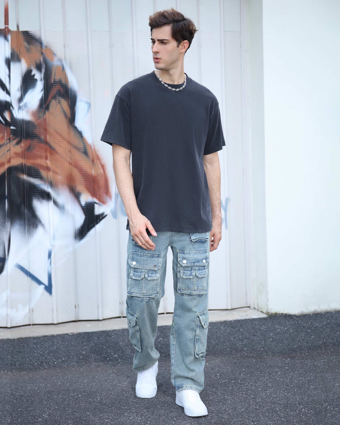 Logeqi black crew neck t-shirt styled with relaxed fit and paired with distressed cargo jeans
