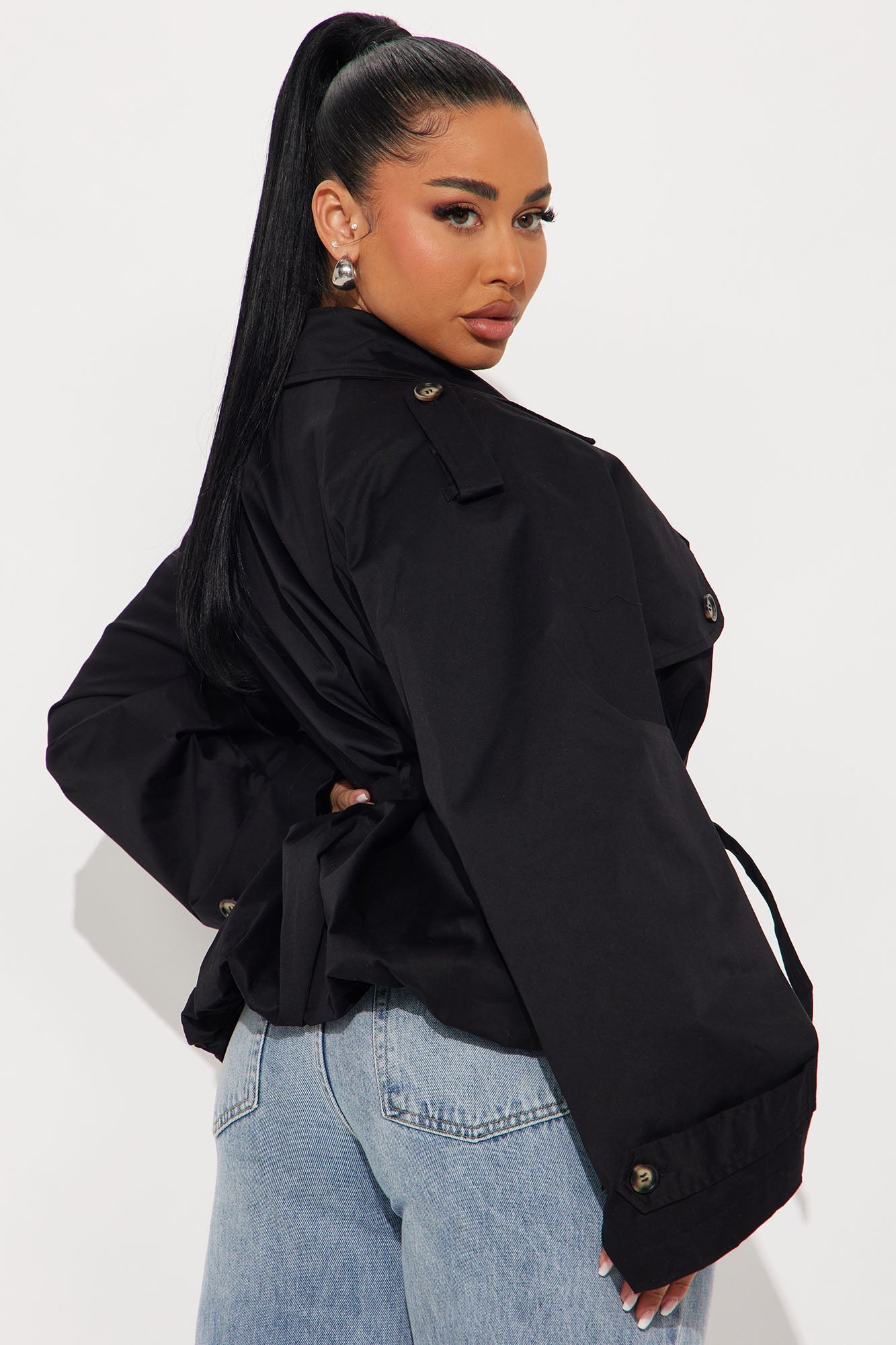 Stylish black cropped trench coat for women featuring a belted waist and oversized sleeves