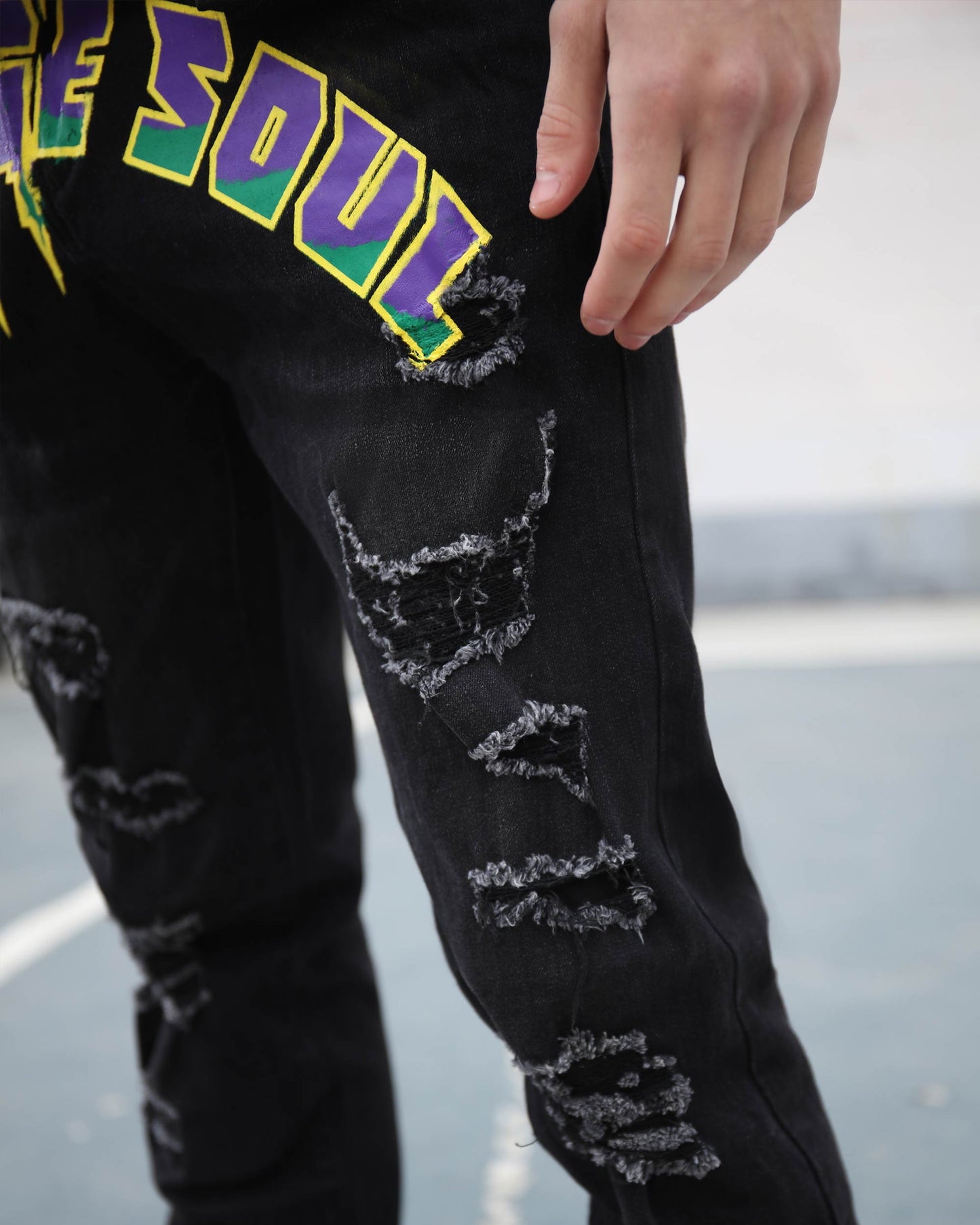 Logeqi black graffiti slim-fit jeans with distressed detailing and colorful graphic design