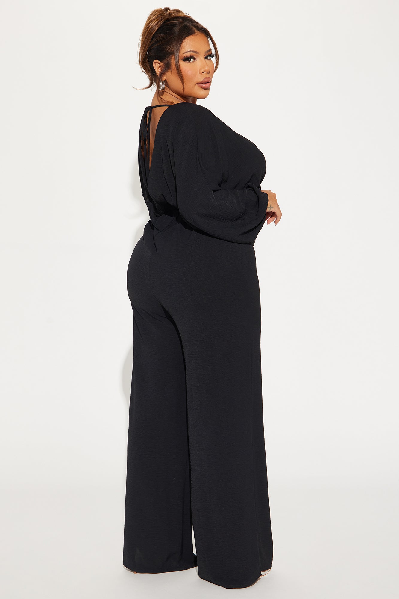 Elegant black jumpsuit for women with a stylish open back design and wide leg fit
