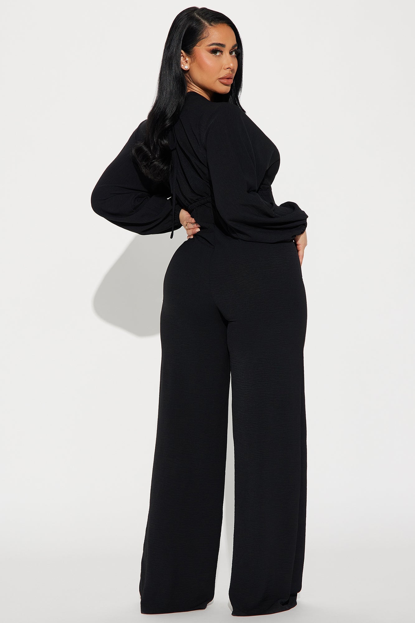 Elegant black jumpsuit for women featuring long sleeves and wide-leg design by Fashion Nova
