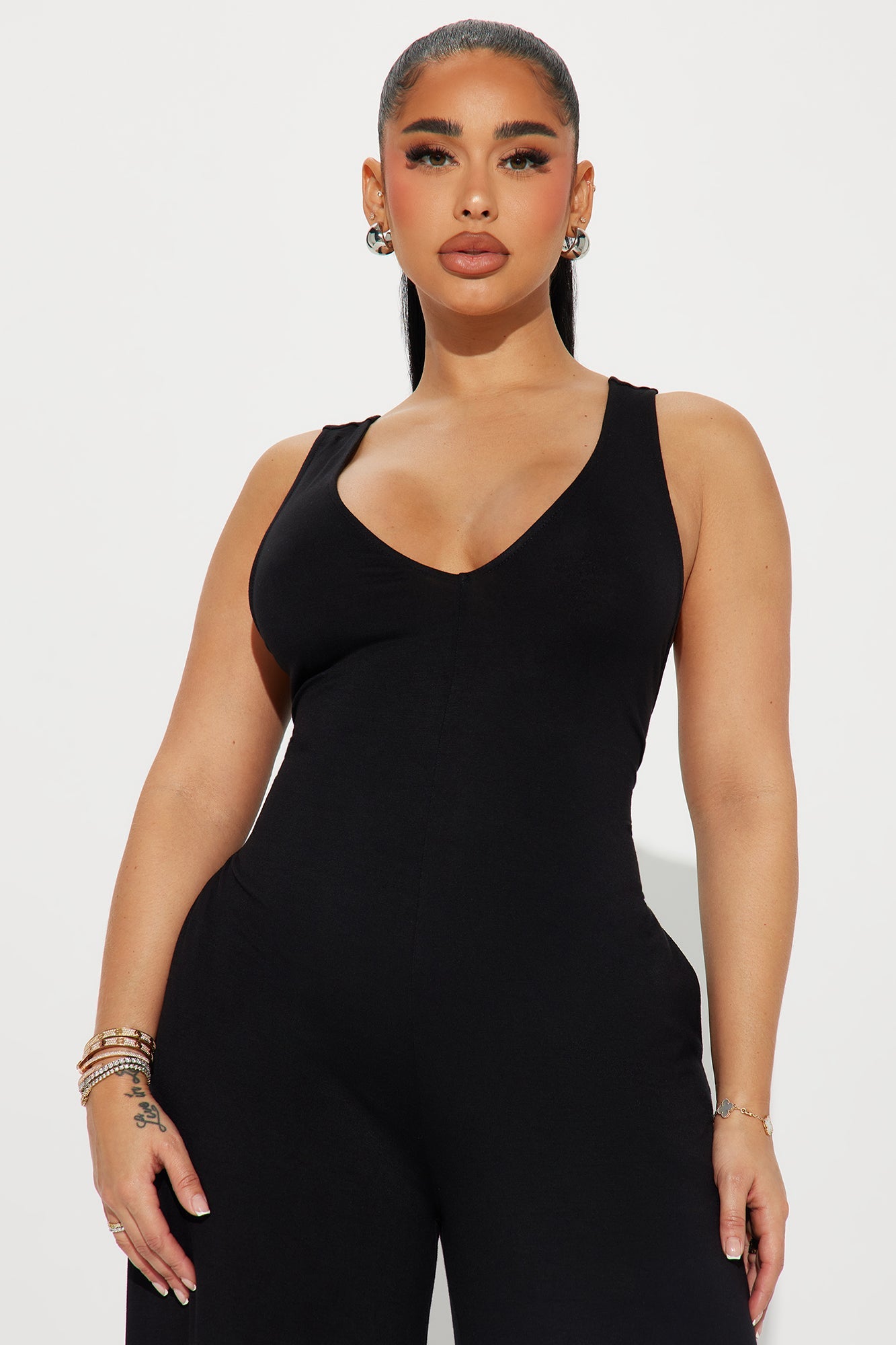 Sleek black jumpsuit for women featuring a flattering V-neckline and a fitted silhouette