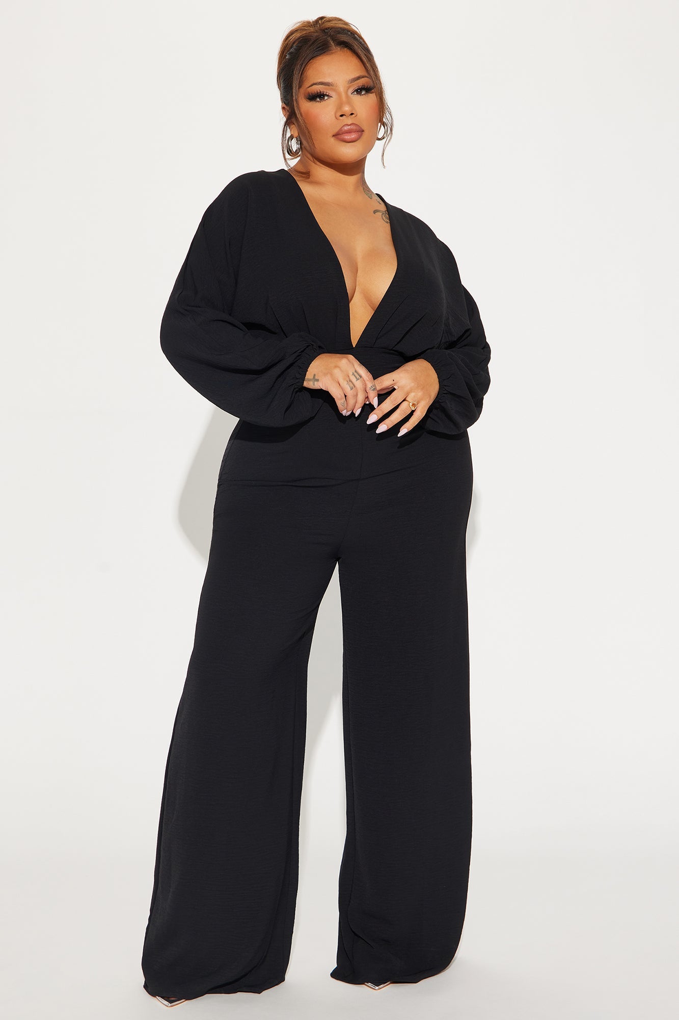Fashion Nova black jumpsuit for women with a deep V-neckline and wide leg design