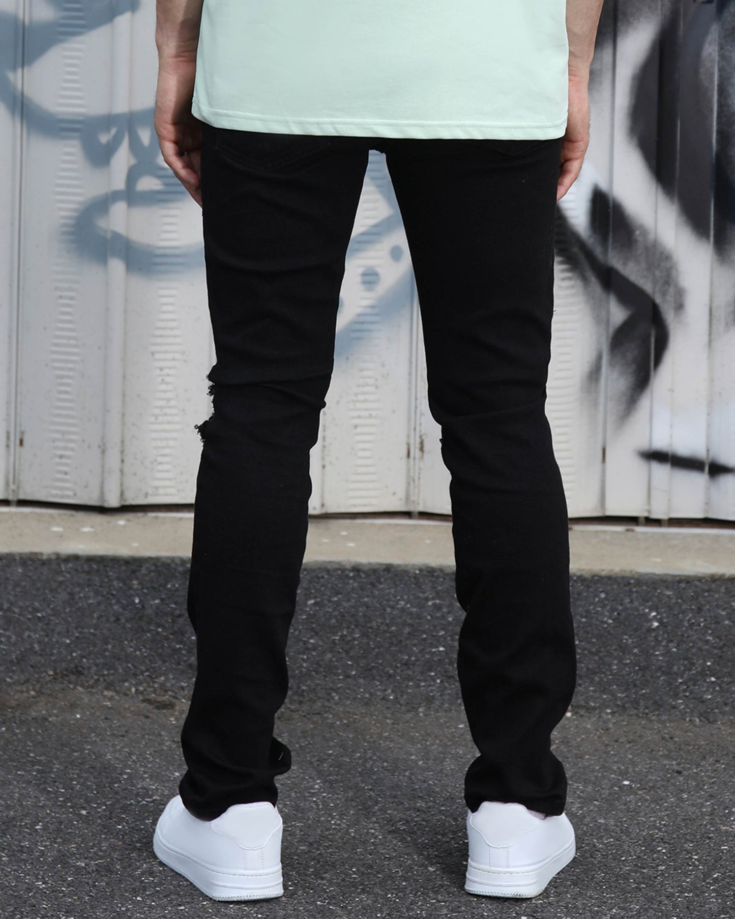 Logeqi black ripped jeans for men, featuring a fitted design and stylish back view