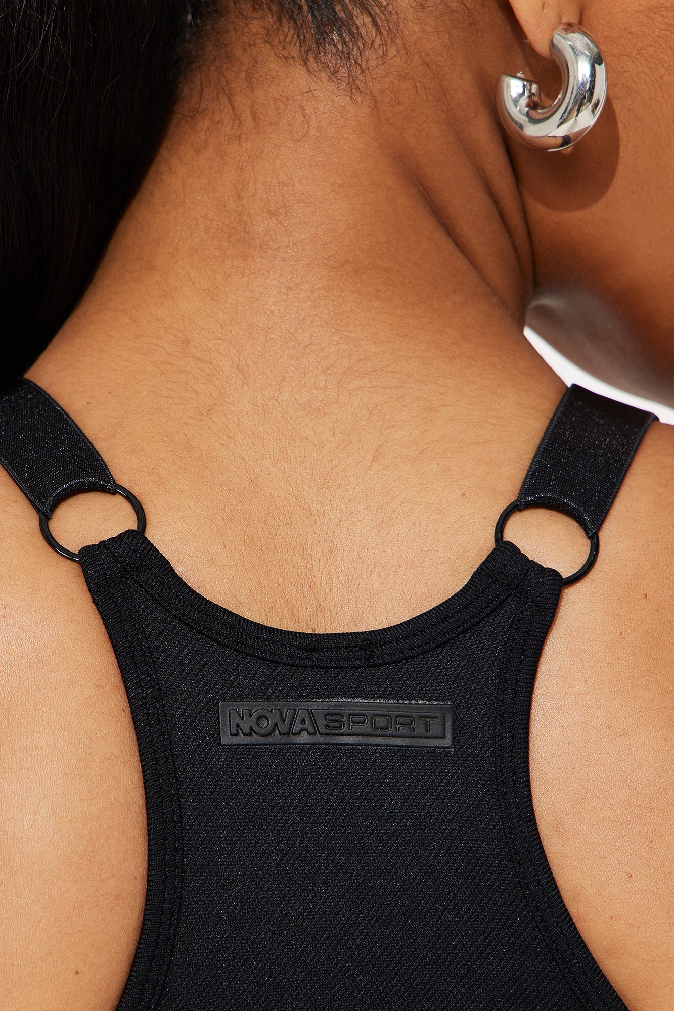 Close-up of the back of a Nova Sport black seamless sports bra with logo detailing