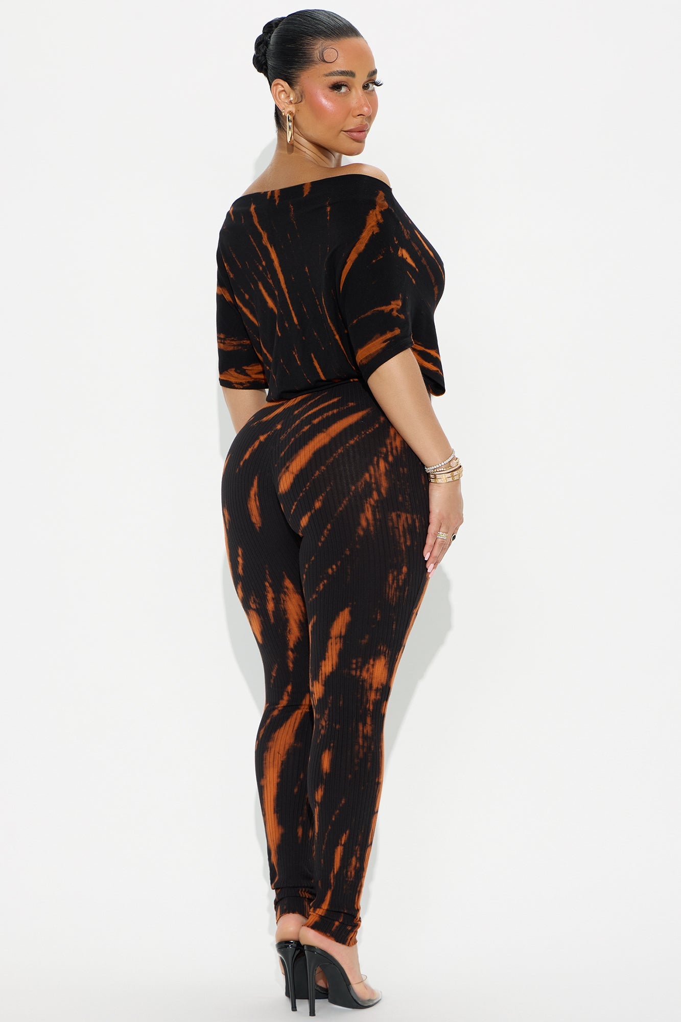 Fashion Nova black tie dye jumpsuit with off-shoulder top and fitted pants on model