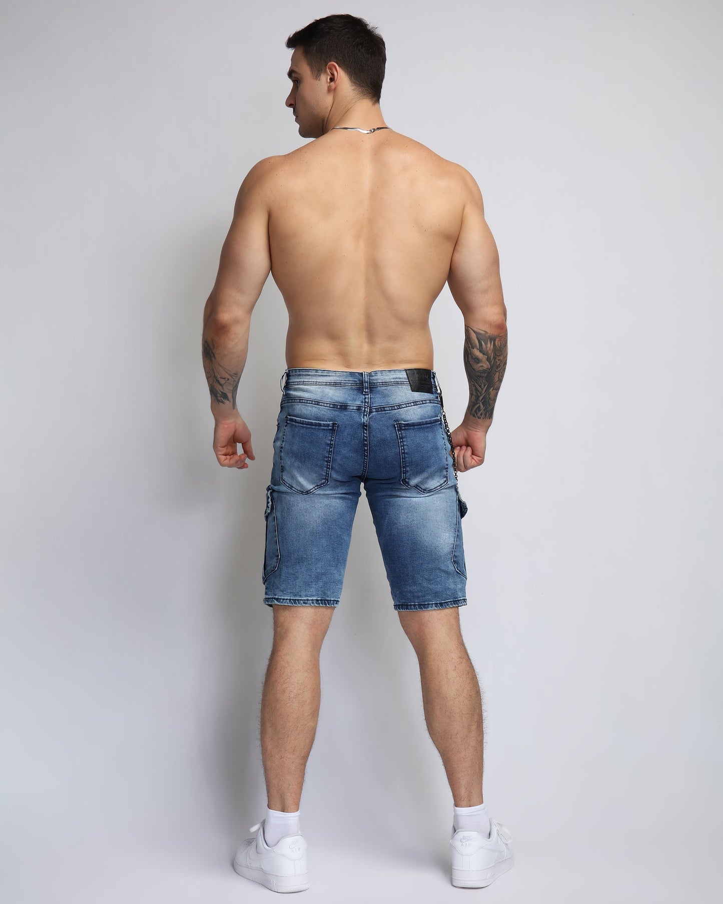 Back view of blue cargo denim shorts from Logeqi on a model showcasing a casual style
