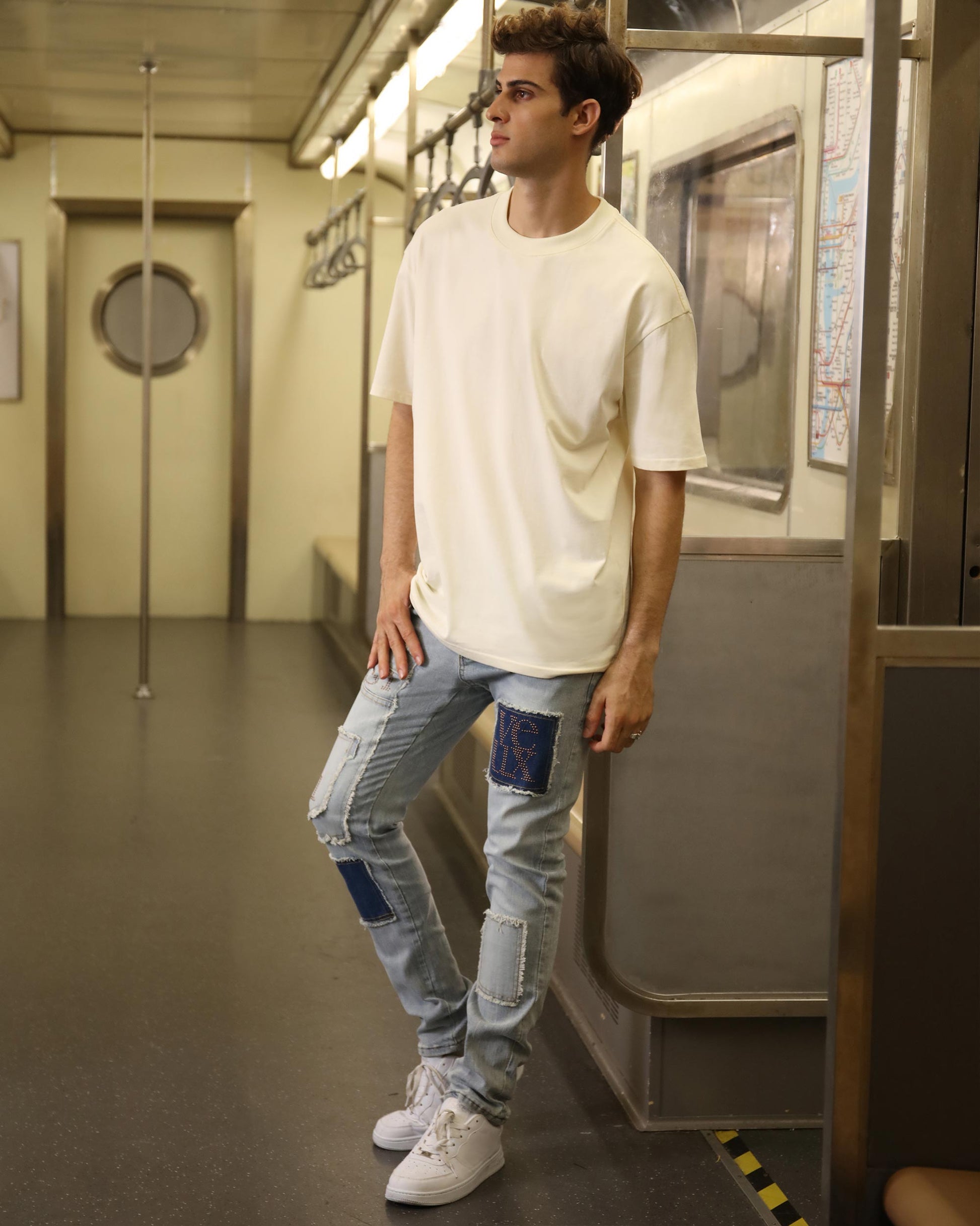 Logeqi blue jeans with diamond accents worn by male model with white sneakers and T-shirt