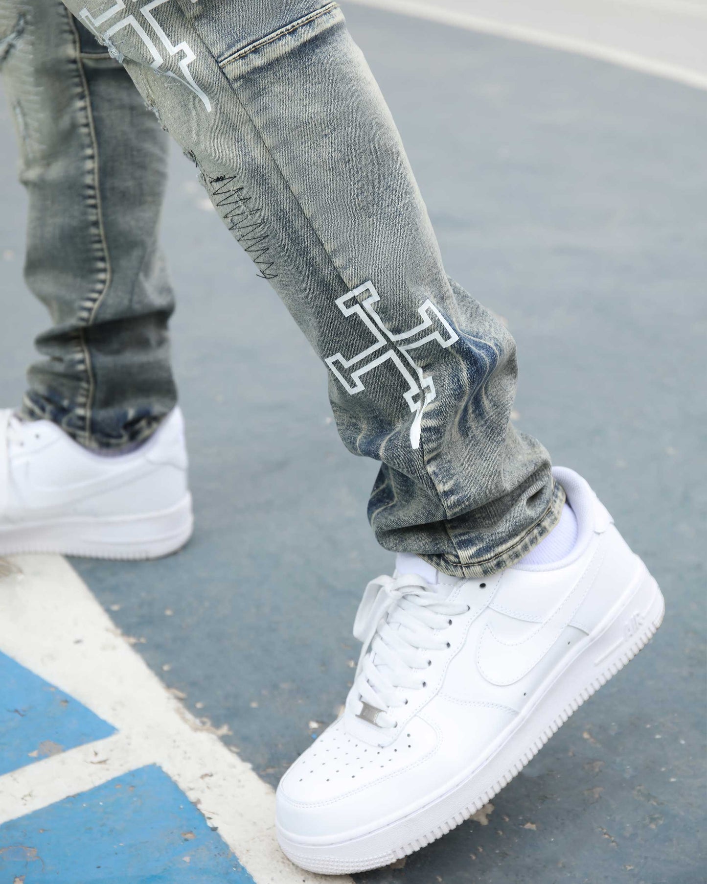 Logeqi blue ripped jeans with skull print featuring a stylish design and a modern fit