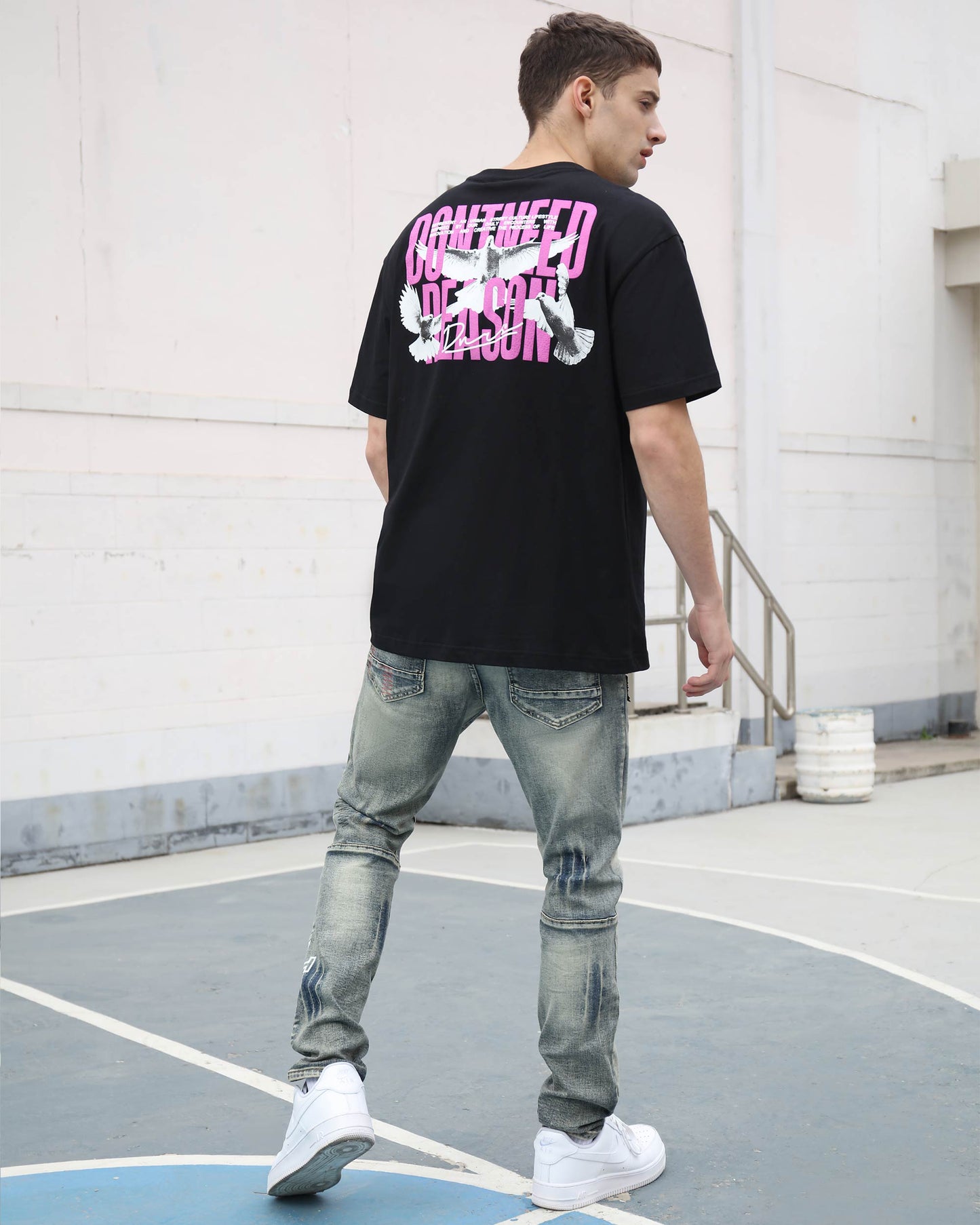Logeqi blue ripped jeans with skull print paired with a black graphic t-shirt for a stylish streetwear look