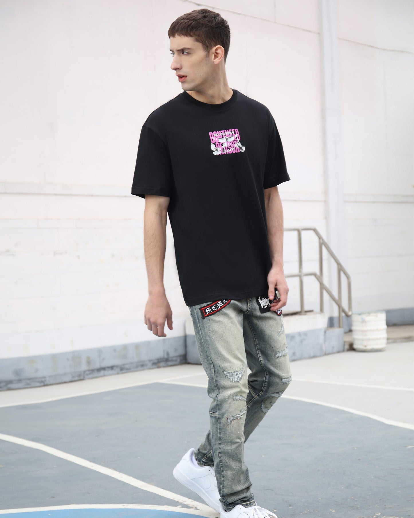 Logeqi blue ripped jeans with skull print paired with a black graphic t-shirt for a trendy look