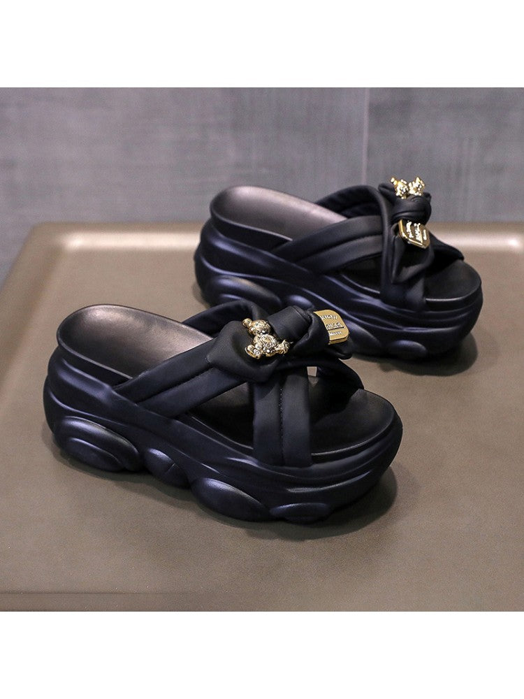 Black bow platform slippers for women with thick cushioned soles and gold embellishments