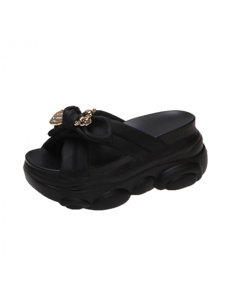 Black bow platform slippers for women with chunky sole and decorative gold chain accents