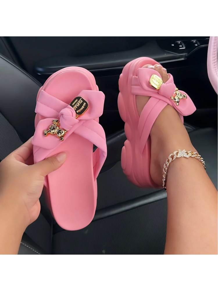 Pink bow platform slippers for women with decorative gold accents and comfortable thick sole