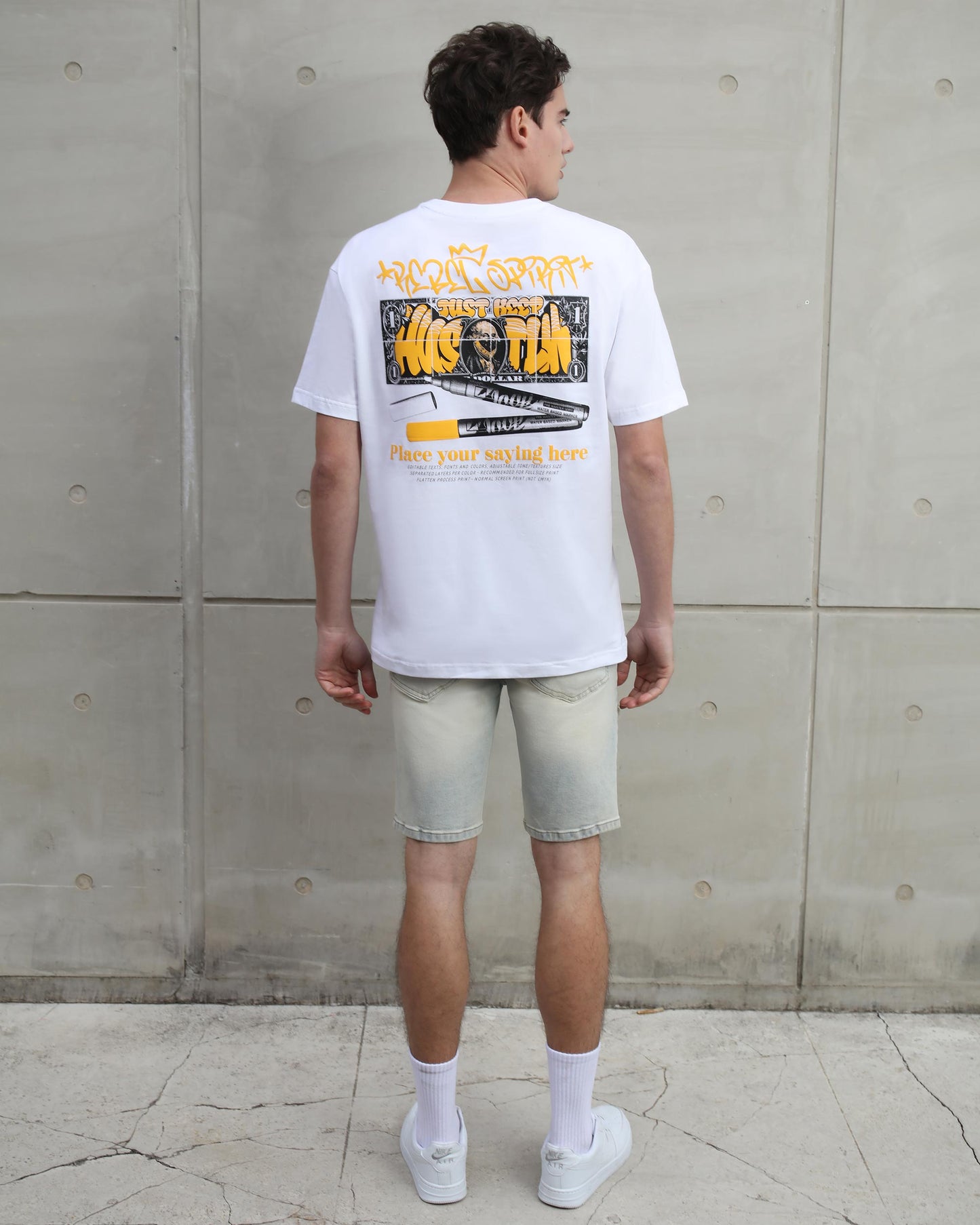 Logeqi distressed graffiti denim shorts worn by model with white graphic t-shirt and sneakers