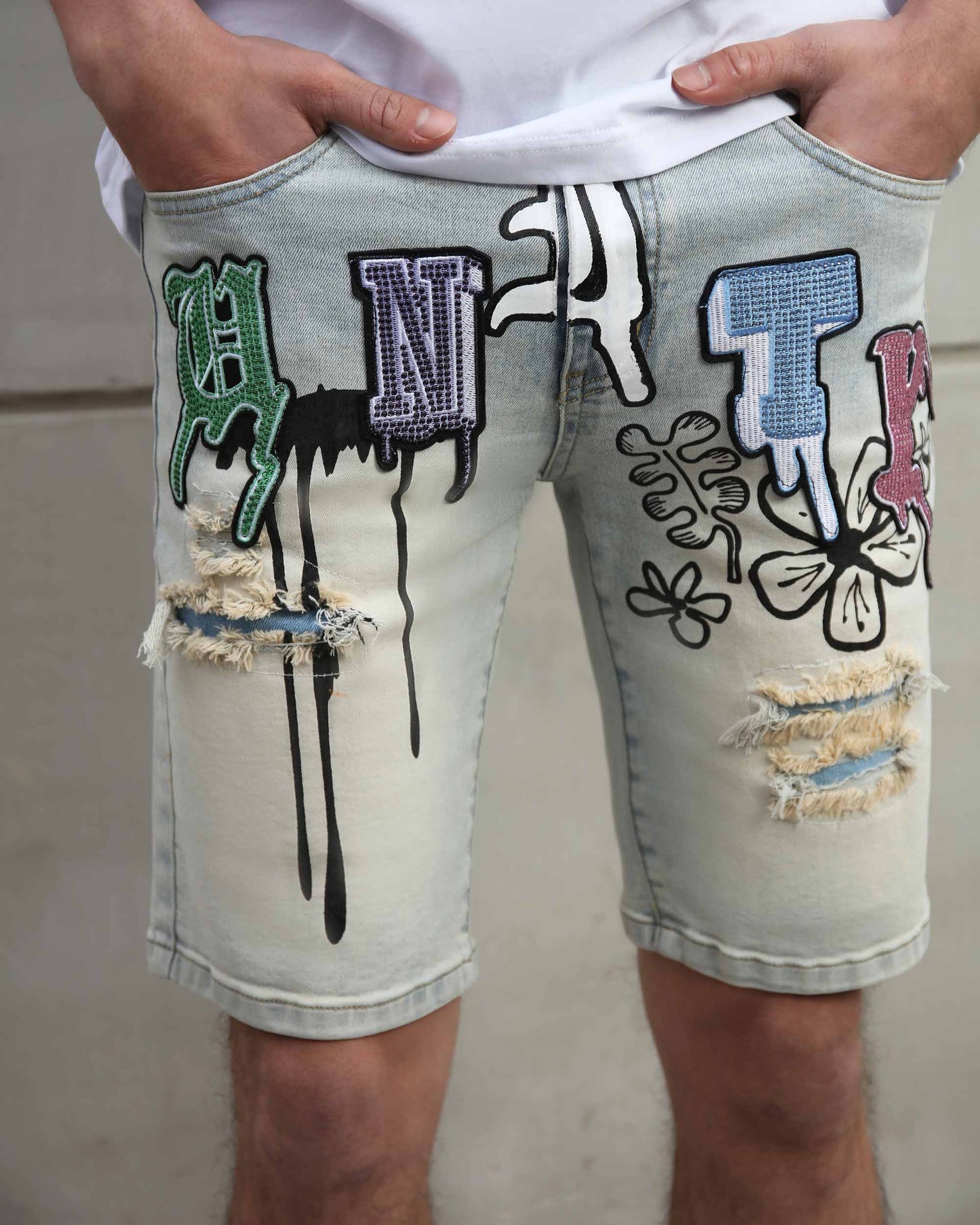 Logeqi distressed graffiti denim shorts with colorful patches and ripped details on light wash denim