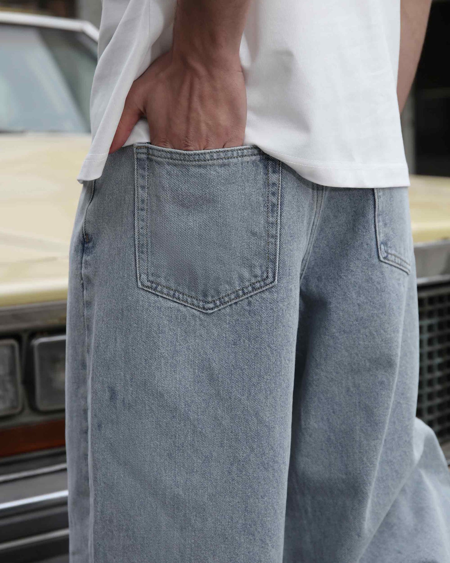 Logeqi loose fit blue jeans with back pocket detail worn with a white shirt