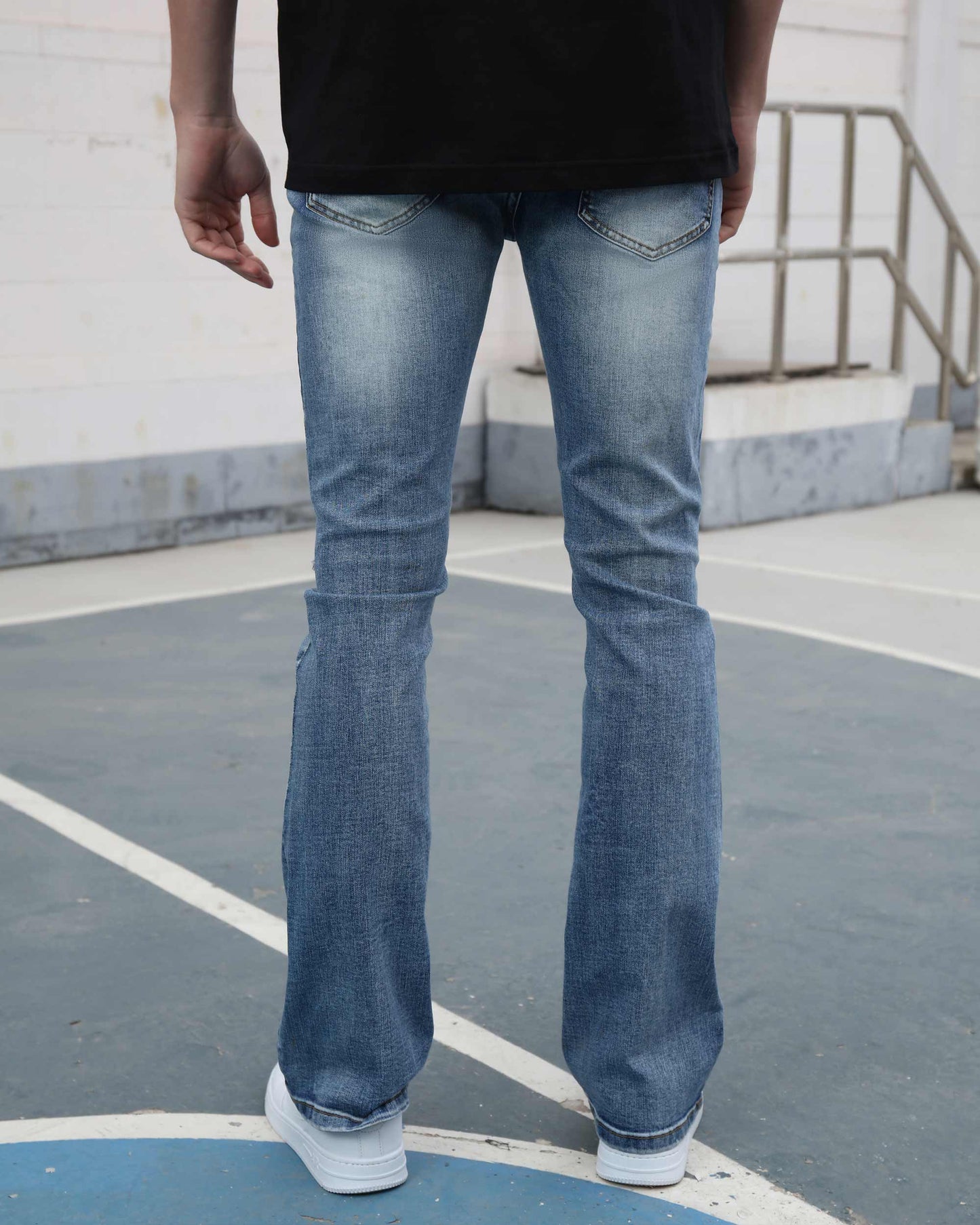 Logeqi medium wash ripped jeans with a straight fit worn by a person standing outdoors