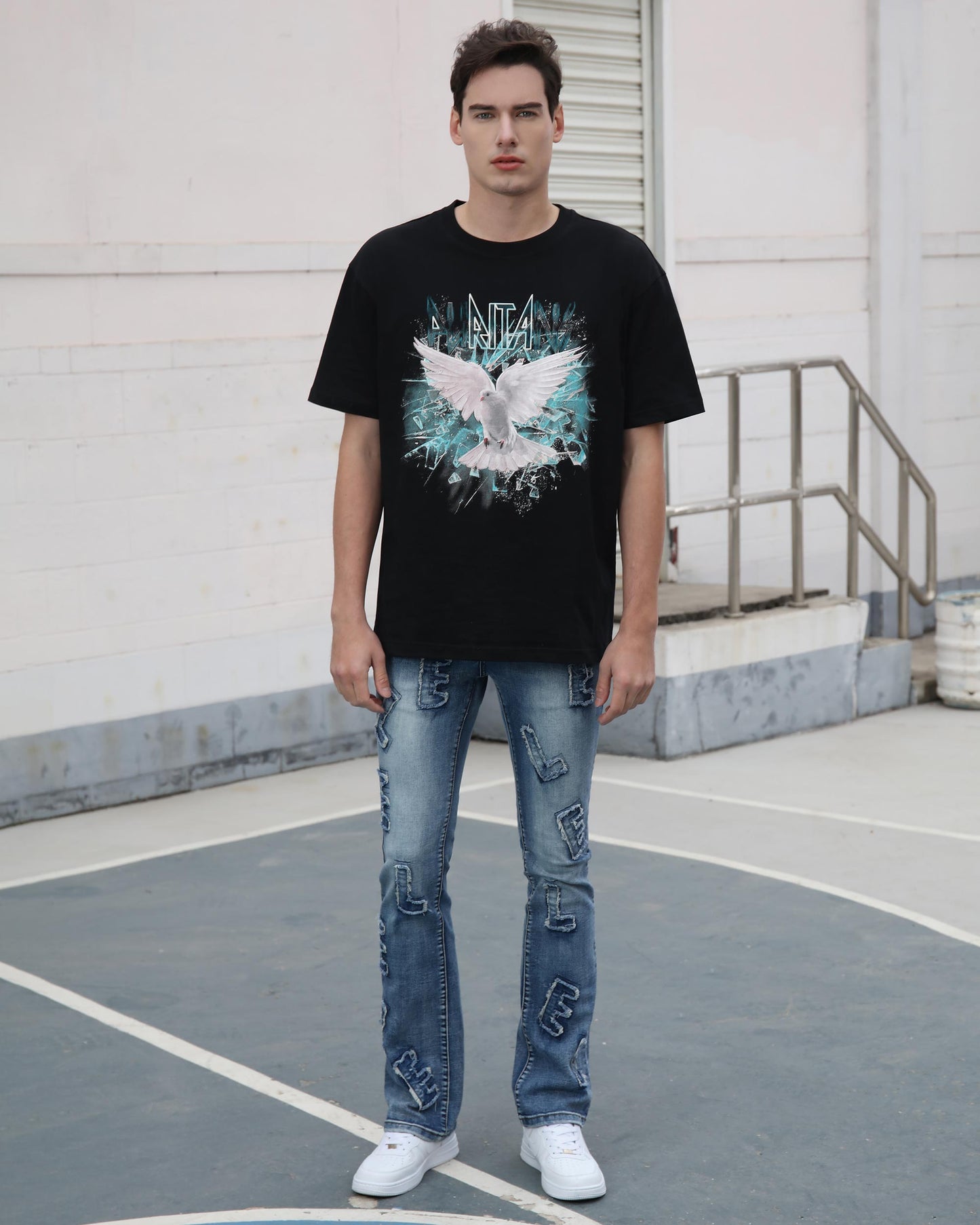 Logeqi medium wash ripped jeans worn by man with black graphic t-shirt and white sneakers
