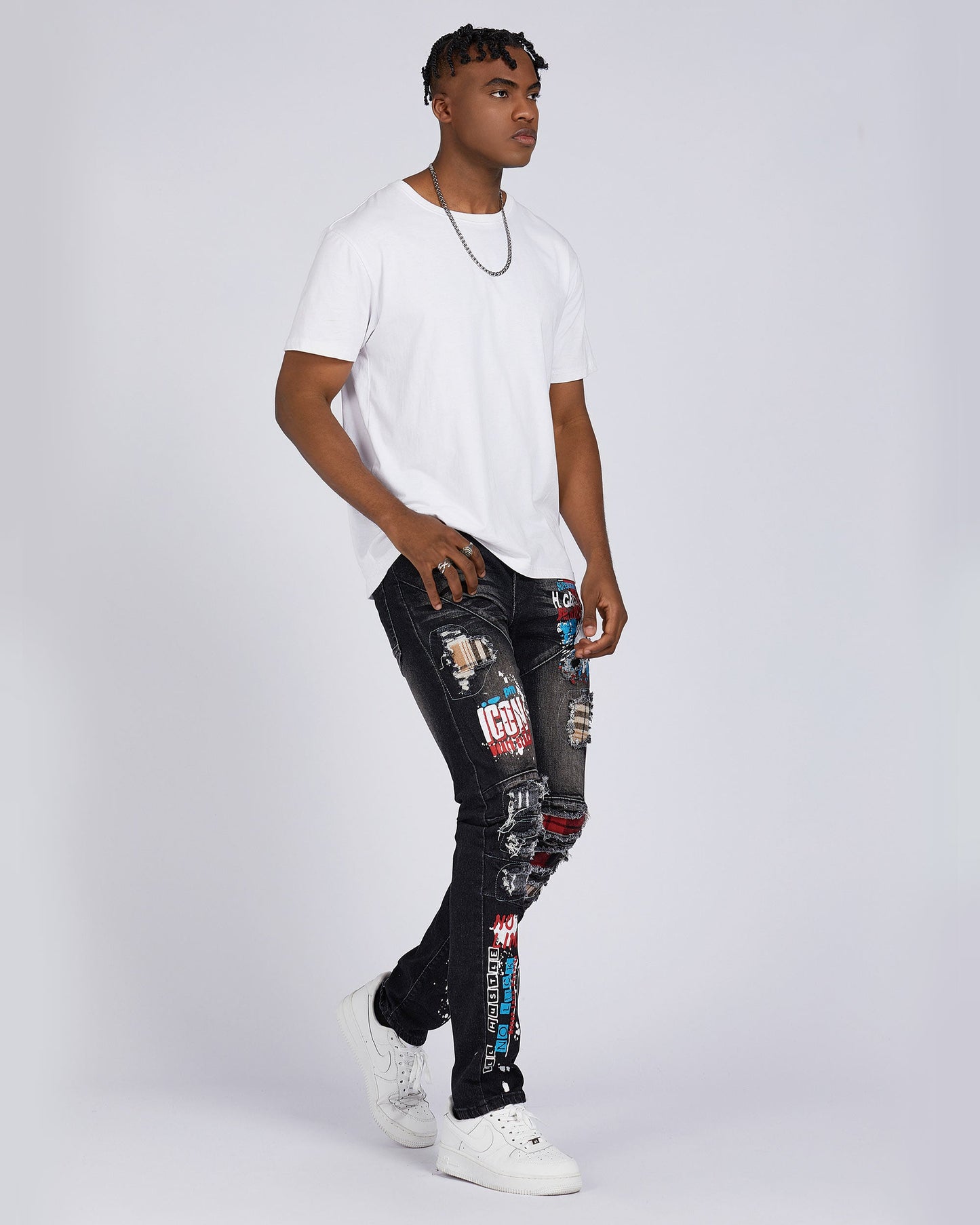 Logeqi slim fit ripped jeans in black with colorful patches worn by male model with white t-shirt