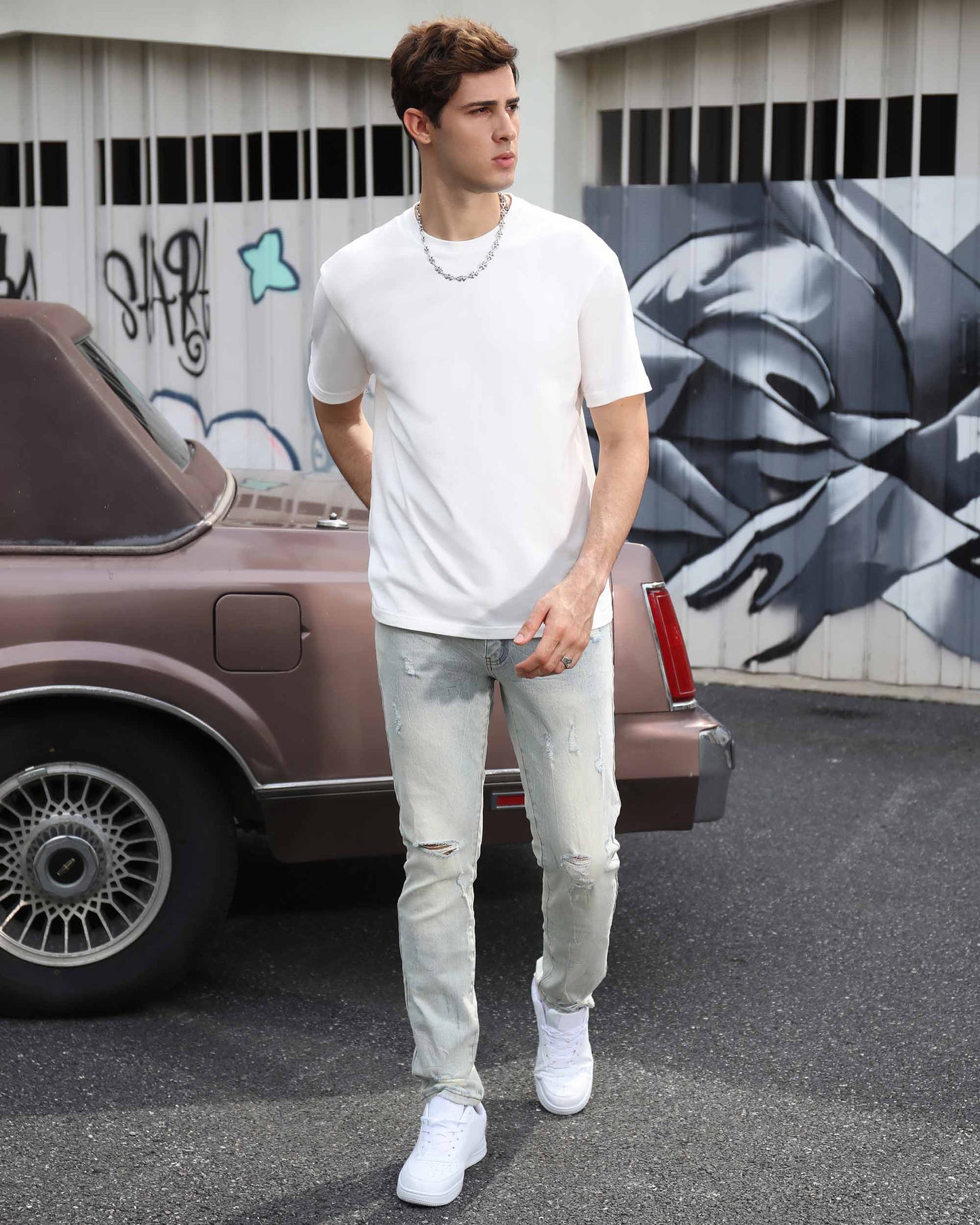 Logeqi straight fit ripped jeans in light wash, styled with a white t-shirt and sneakers