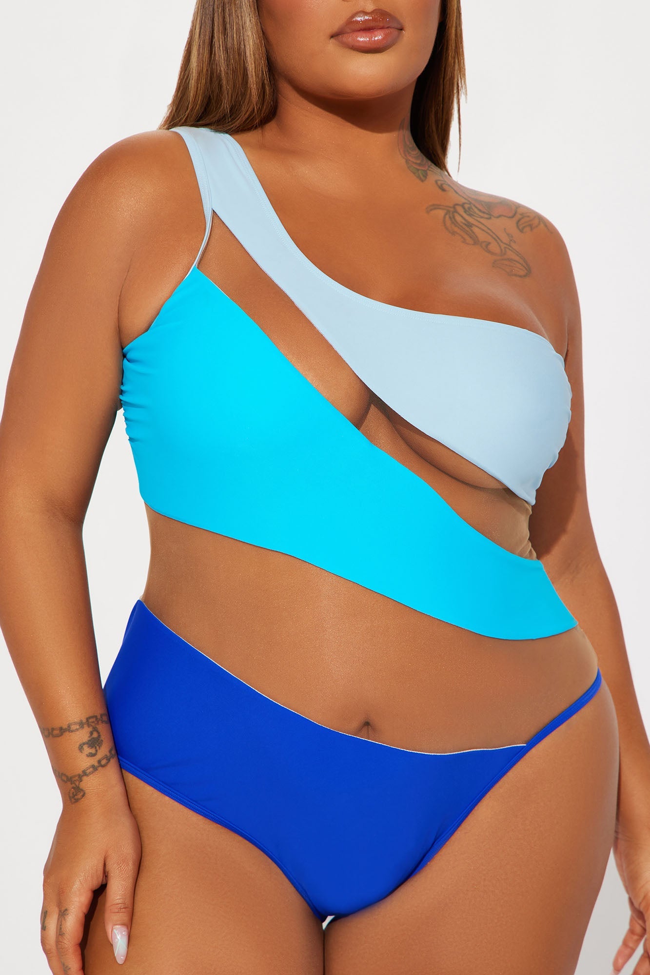Fashion Nova cutout mesh one-piece swimsuit asymmetrical colorblock blues on plus size model