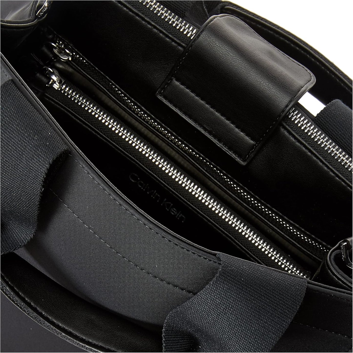 Interior view of a Calvin Klein crossbody bag for women featuring multiple pockets and premium materials