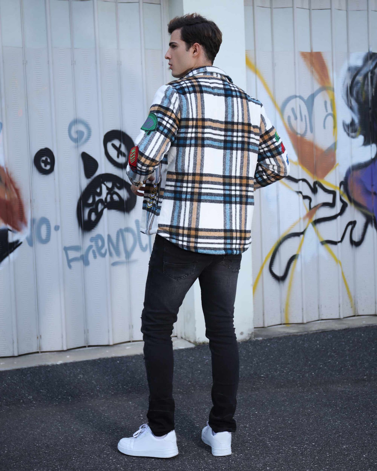 Logeqi checkered plaid moto jacket with colorful patches, styled with black jeans and white sneakers