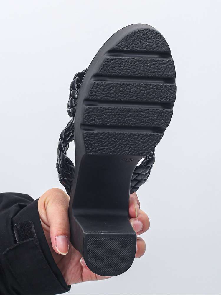 Black chunky heel slippers for women showing textured sole and braided straps