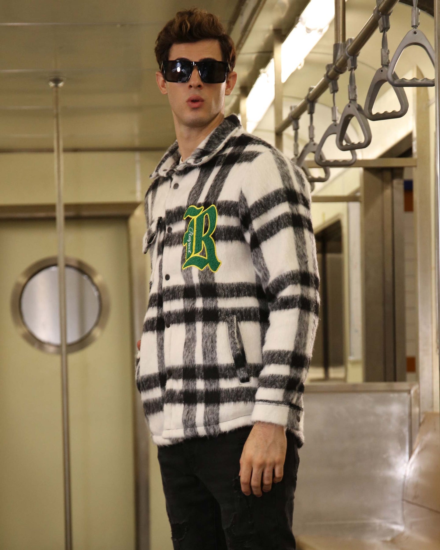 Logeqi classic plaid moto jacket in black and white with green letter patch worn by man with sunglasses