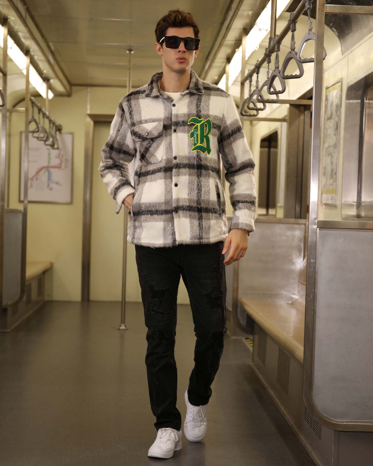 Logeqi classic plaid moto jacket in black and white worn by man with sunglasses inside a subway train