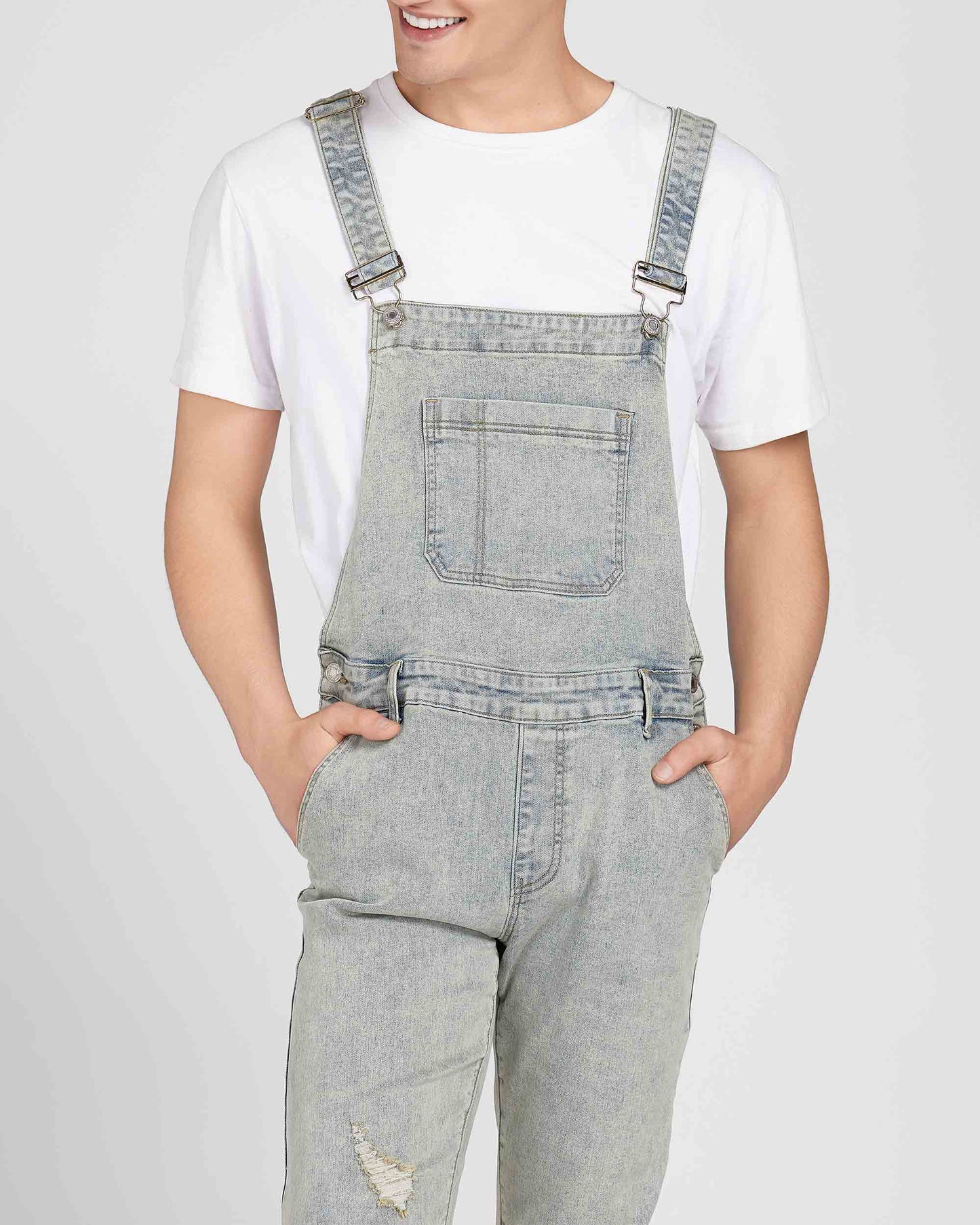 Logeqi classic ripped overalls in light wash denim worn over a white t-shirt with front pocket detail