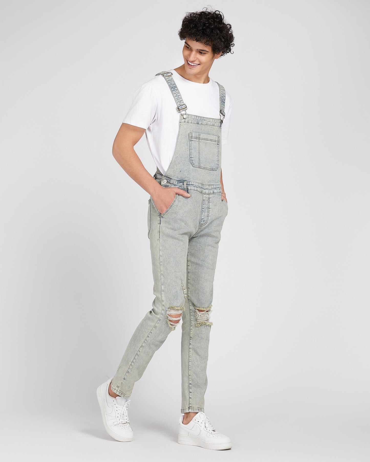 Logeqi classic ripped overalls in light gray denim worn with white sneakers and white t-shirt