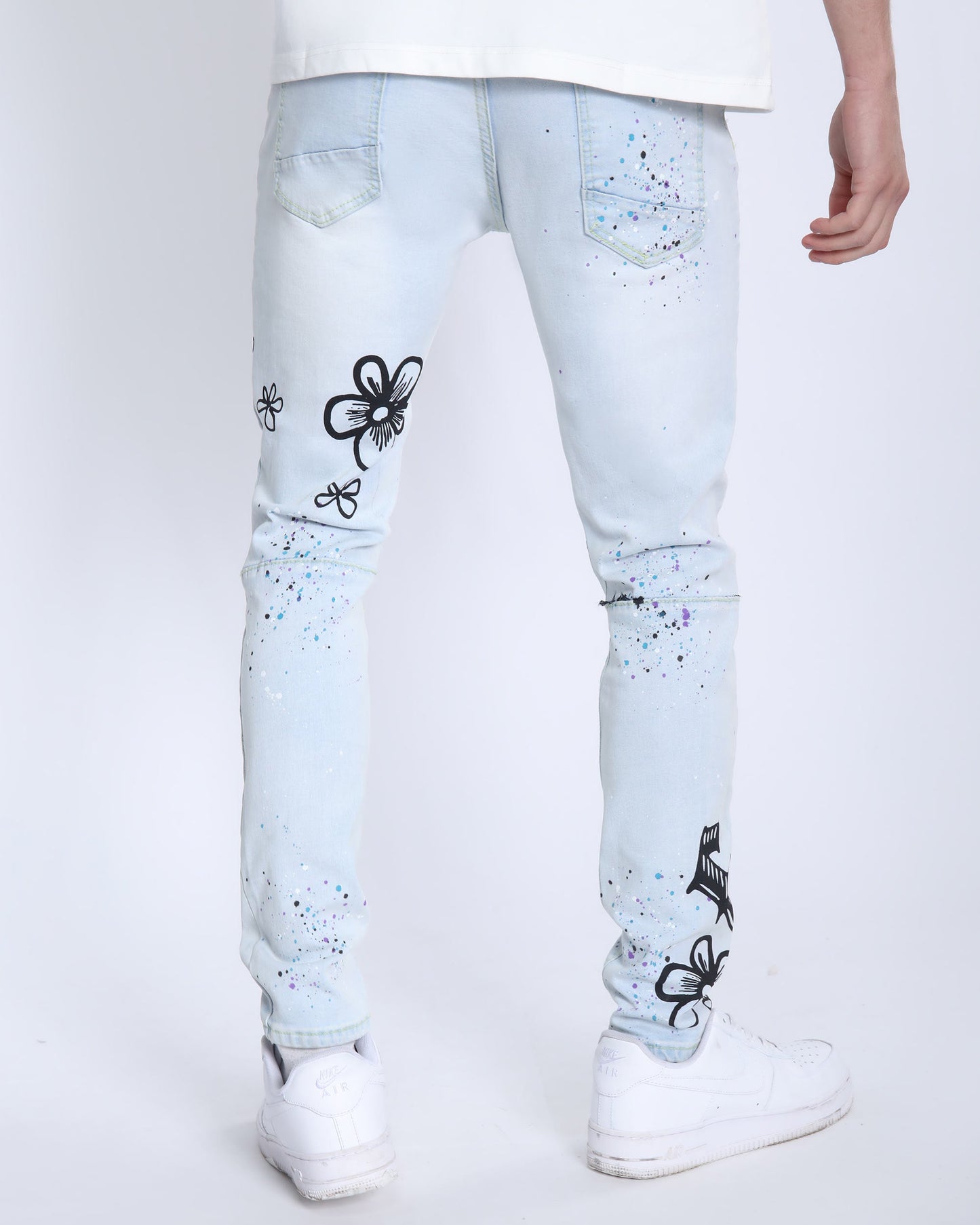 Logeqi light blue comic painted ripped jeans with black floral designs and paint splatter details