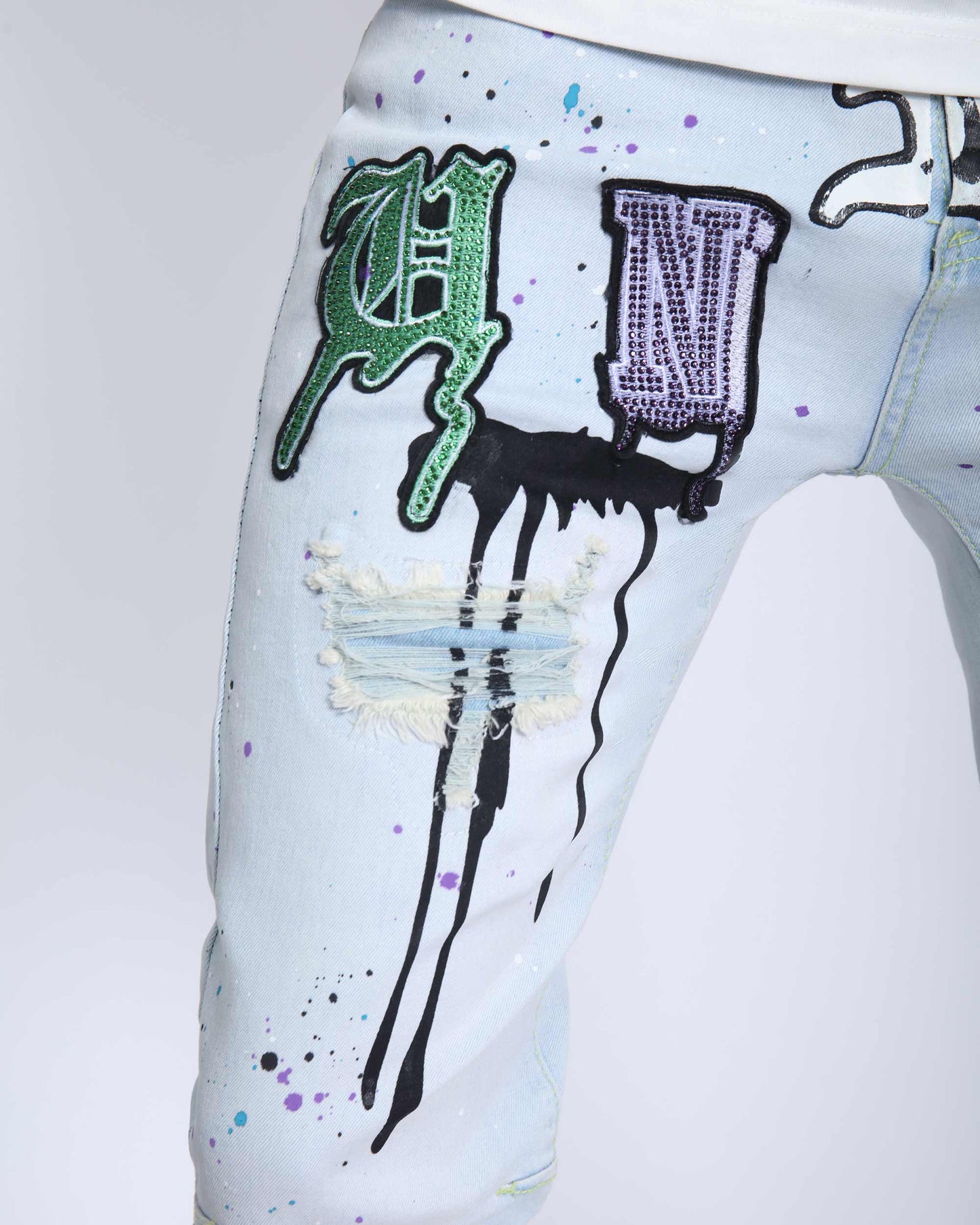 Logeqi comic painted ripped jeans with colorful paint splatters and patch details on light denim