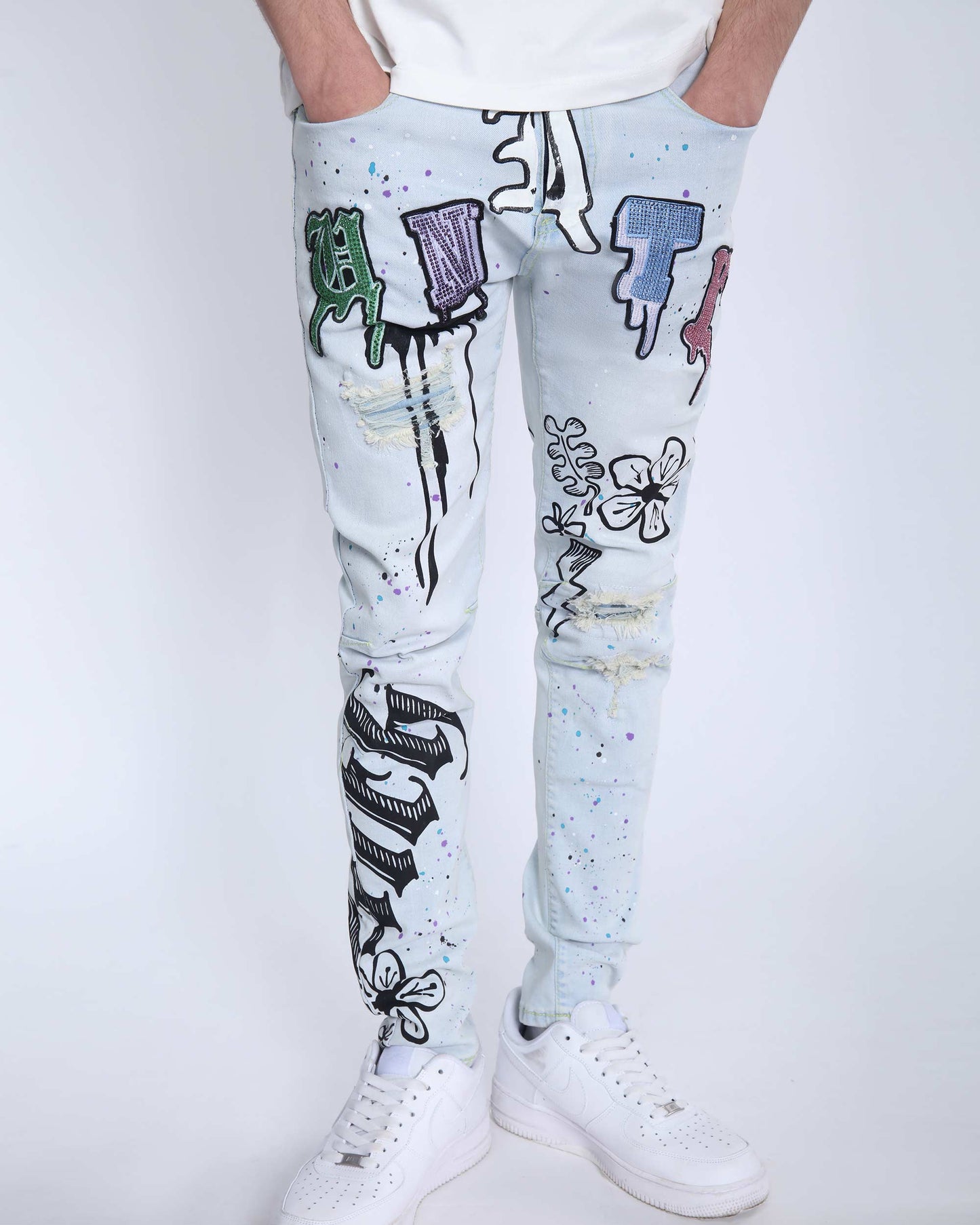Logeqi comic painted ripped jeans with colorful graffiti and distressed details on light denim