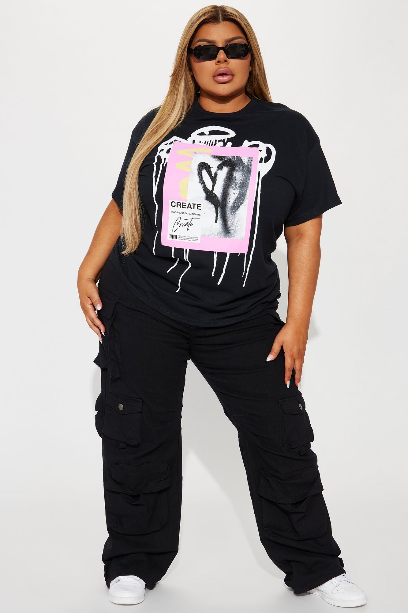 Fashion Nova create love graffiti t-shirt with graphic design paired with black cargo pants