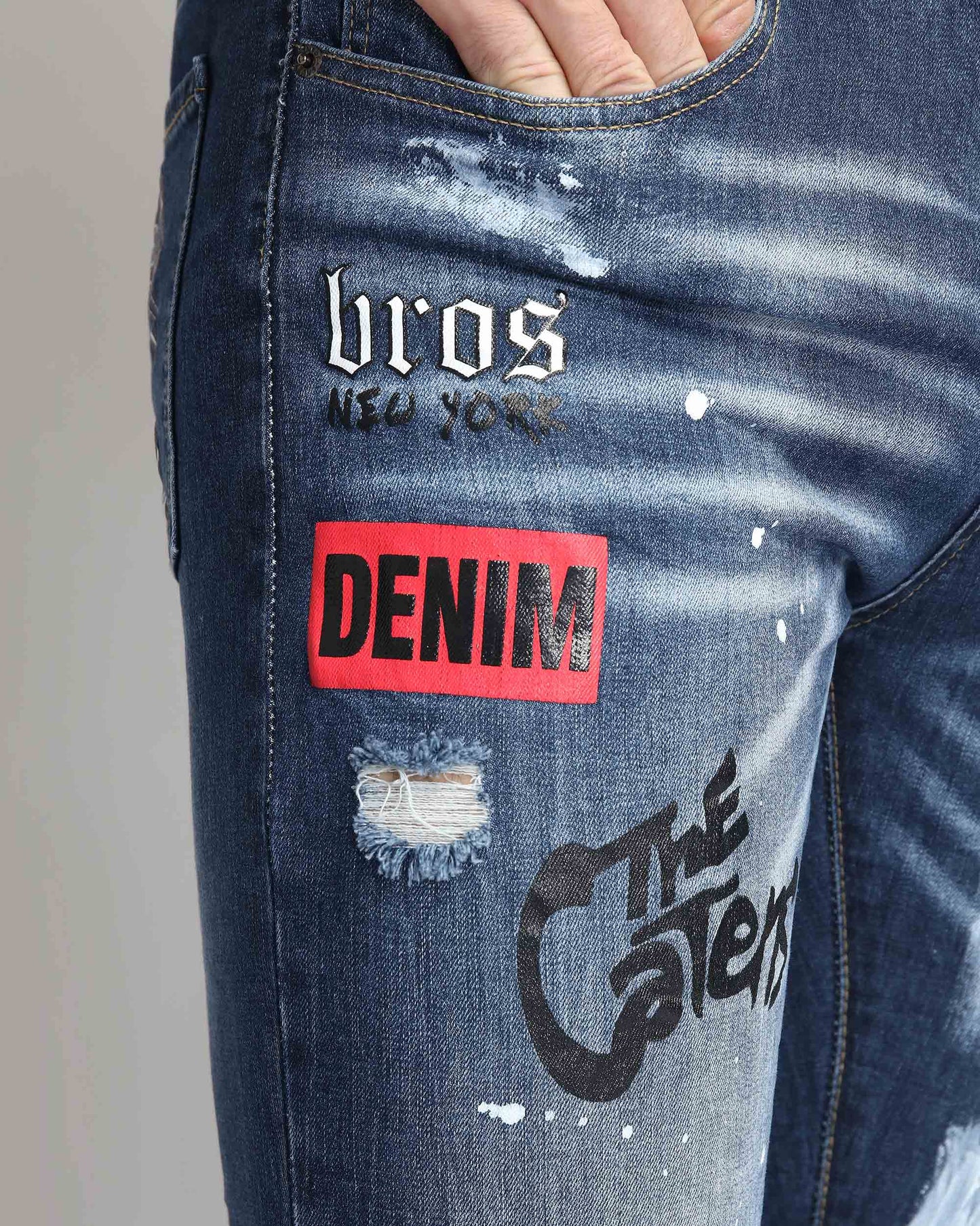 Logeqi dark blue graffiti jeans featuring unique patches and distressed detailing for a trendy look