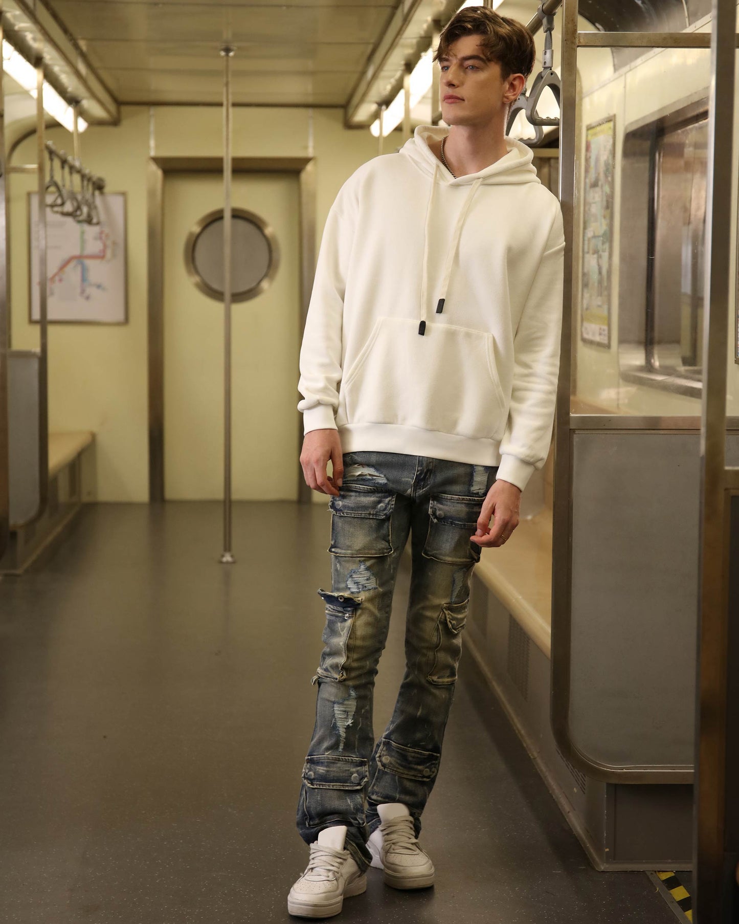 Logeqi dark wash cargo jeans with a relaxed fit and distressed details, styled in a subway setting