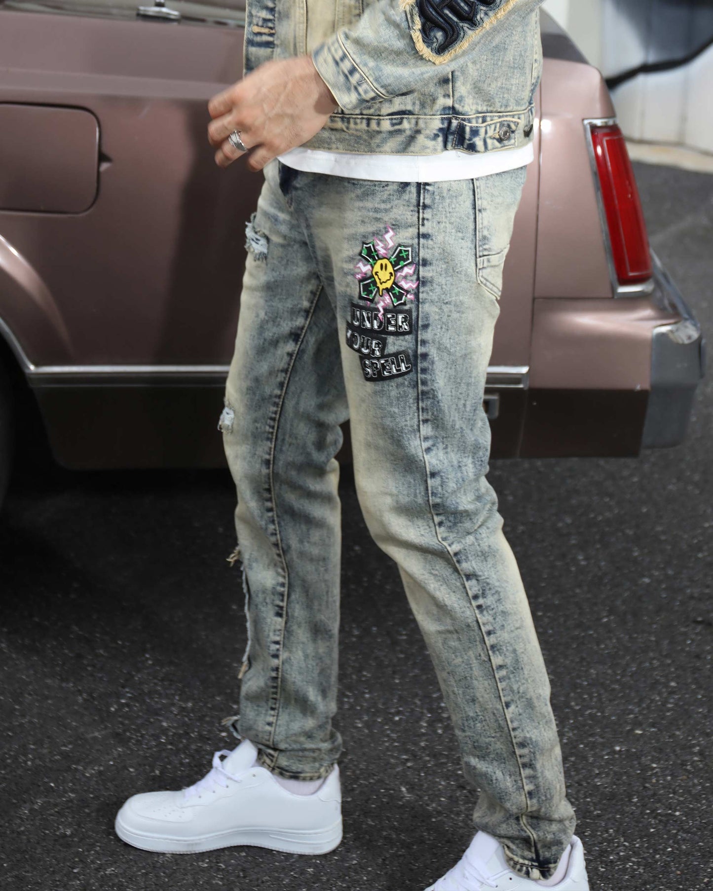 Logeqi dark washed straight leg jeans featuring ripped details and embroidered patches for a stylish look