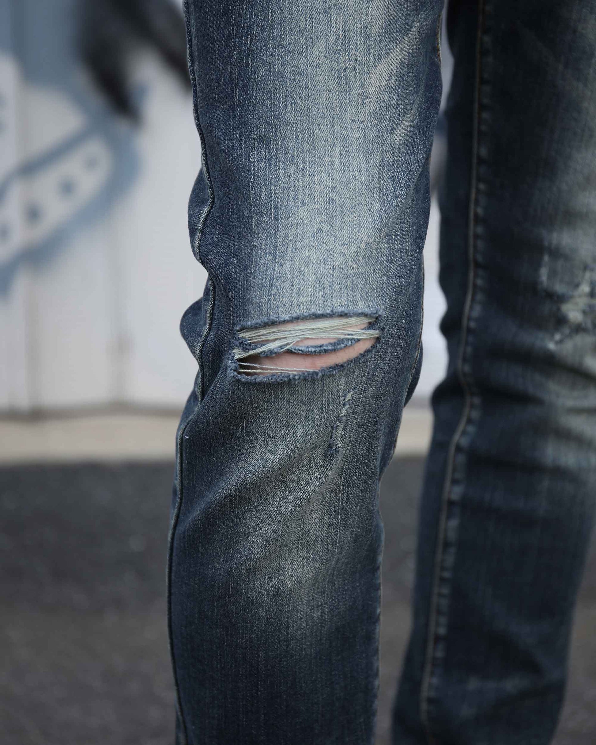 Logeqi slim fit ripped jeans men in faded blue denim with distressed tear on knee