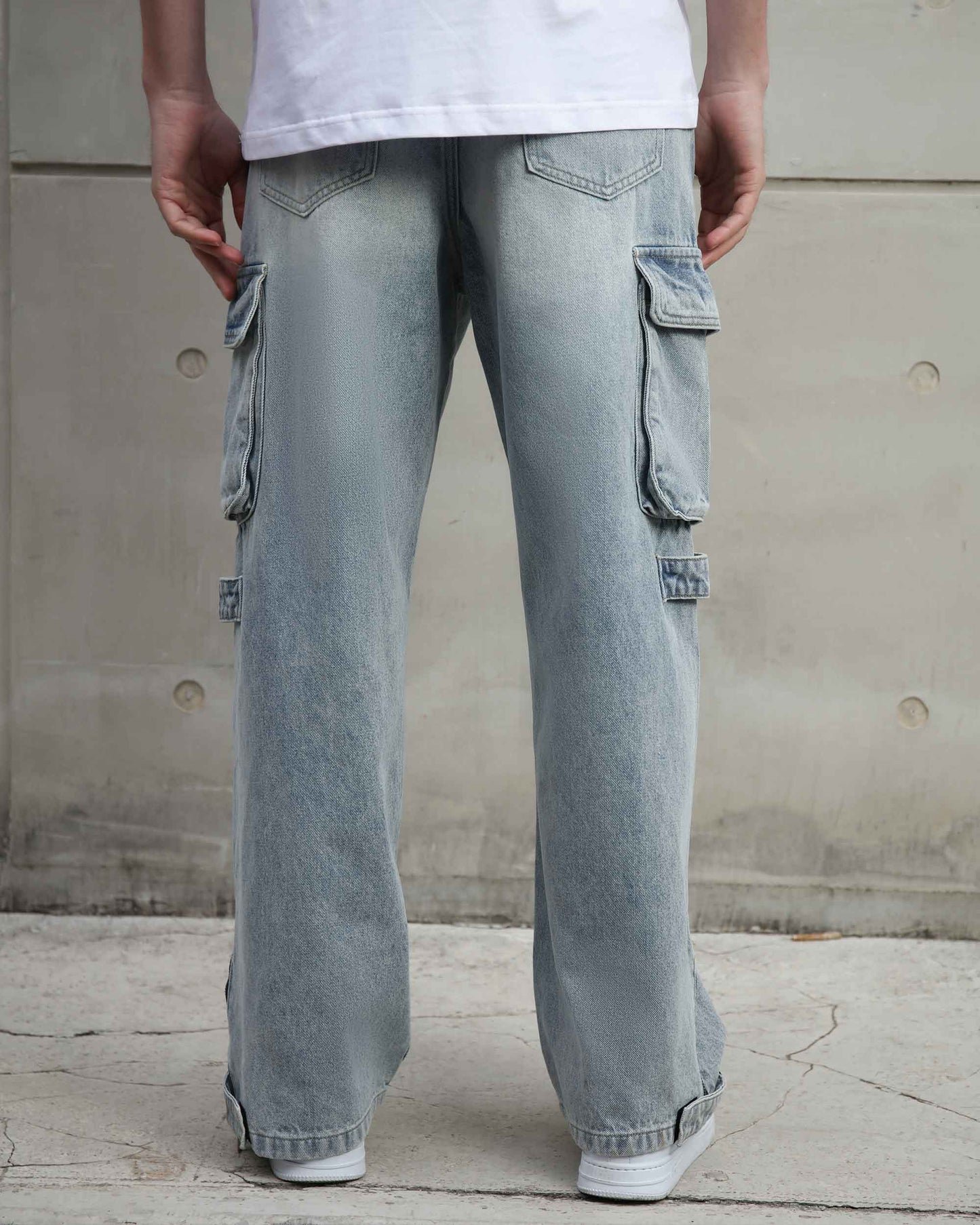 Logeqi distressed blue baggy jeans with side cargo pockets and relaxed fit on model