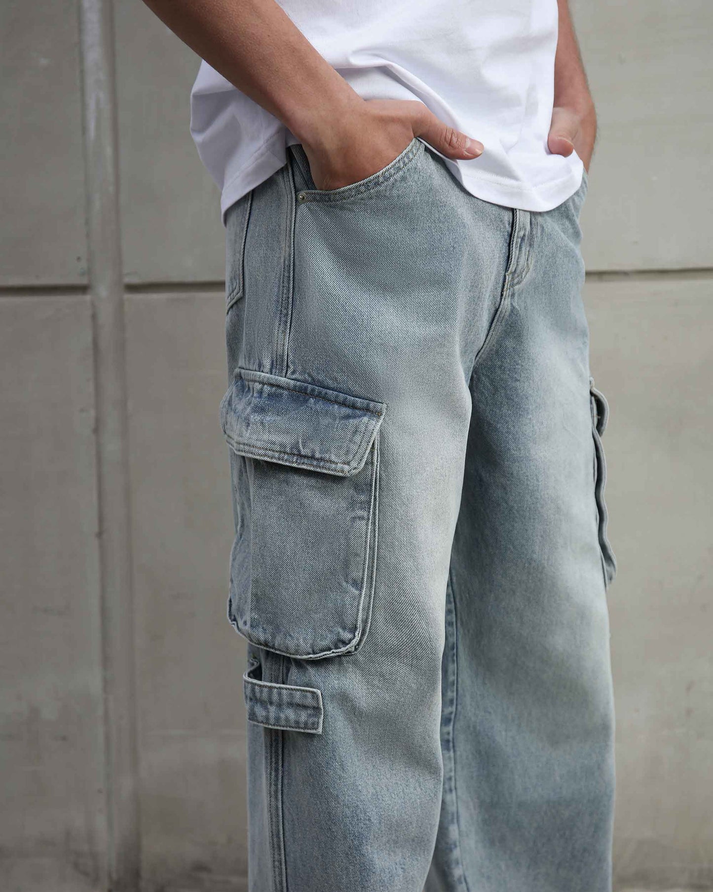 Logeqi distressed blue baggy jeans with cargo pockets worn with white t-shirt