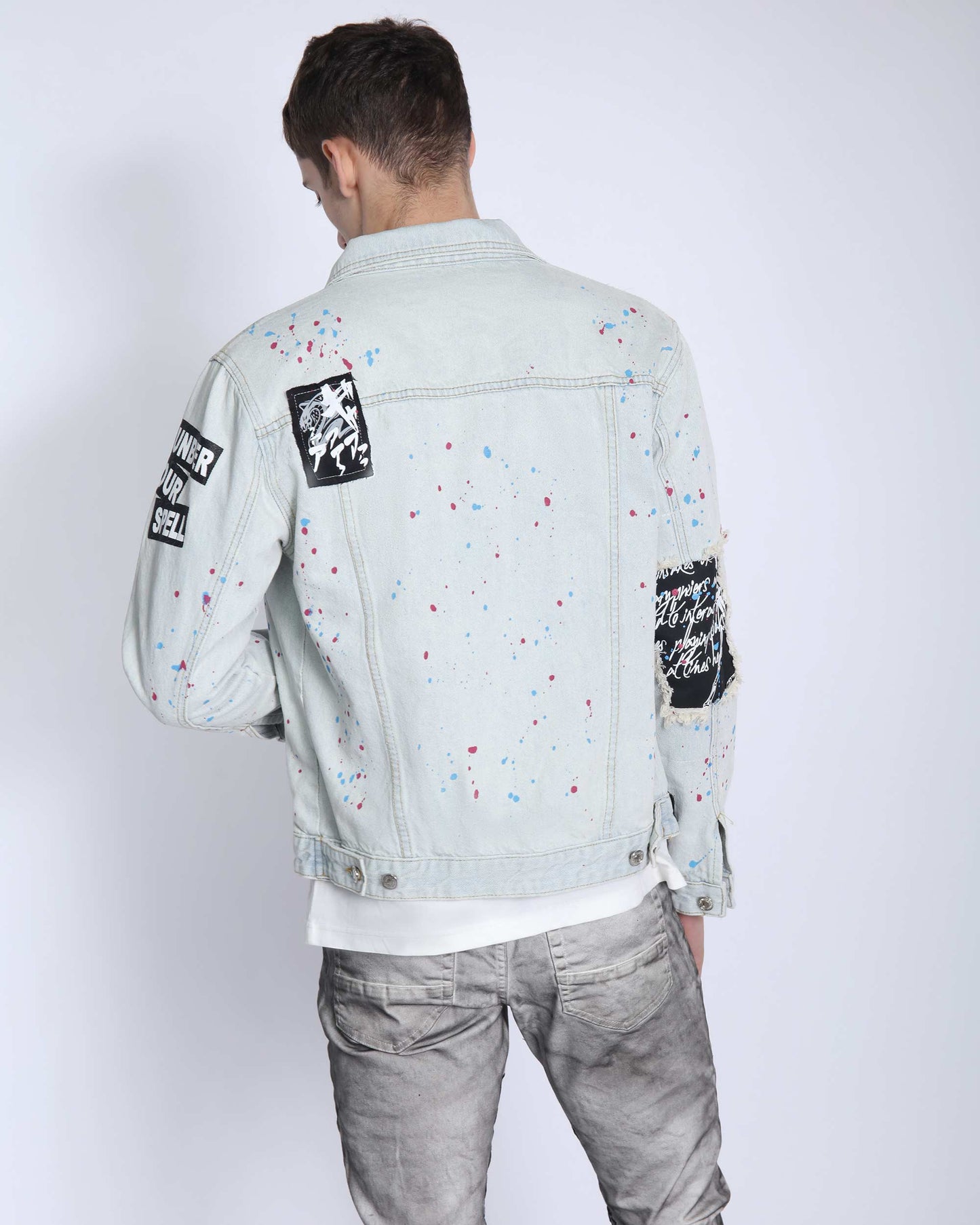 Logeqi distressed blue denim jacket with unique paint splatter design and black patches on sleeves
