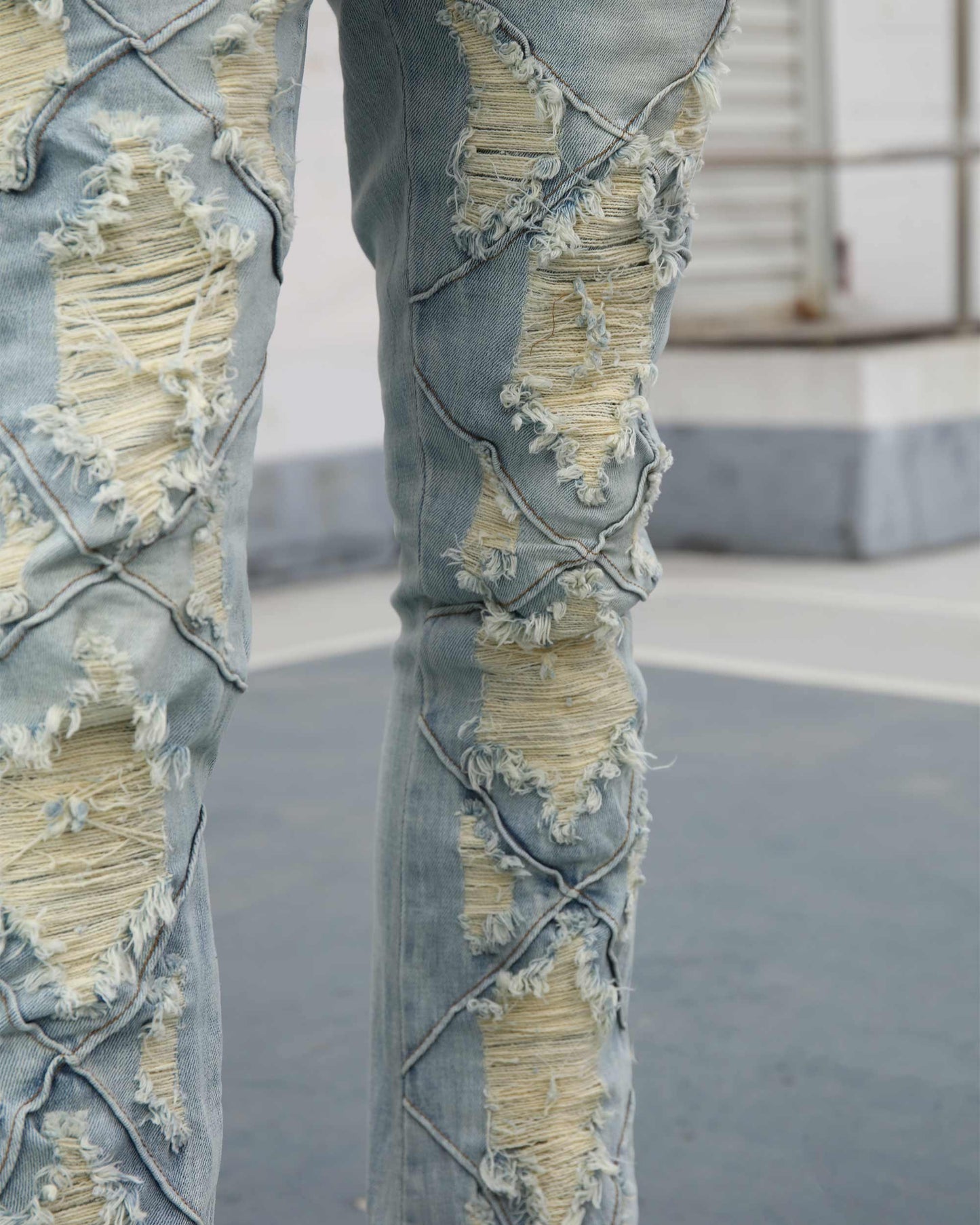 Logeqi distressed blue jeans with unique torn detailing for a trendy casual look