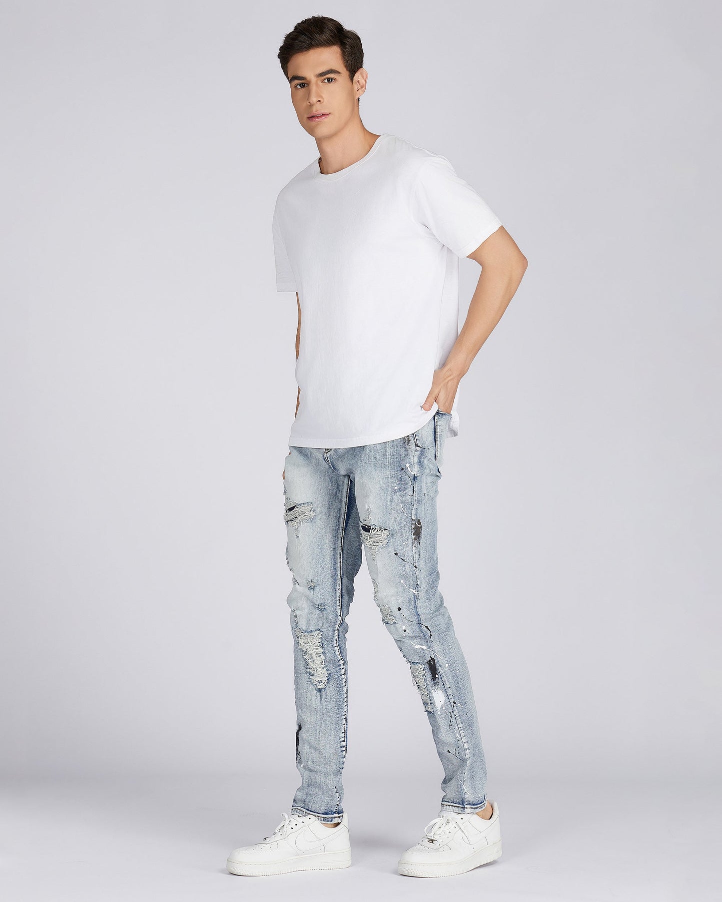 Logeqi distressed blue jeans paired with a white t-shirt for a casual stylish look